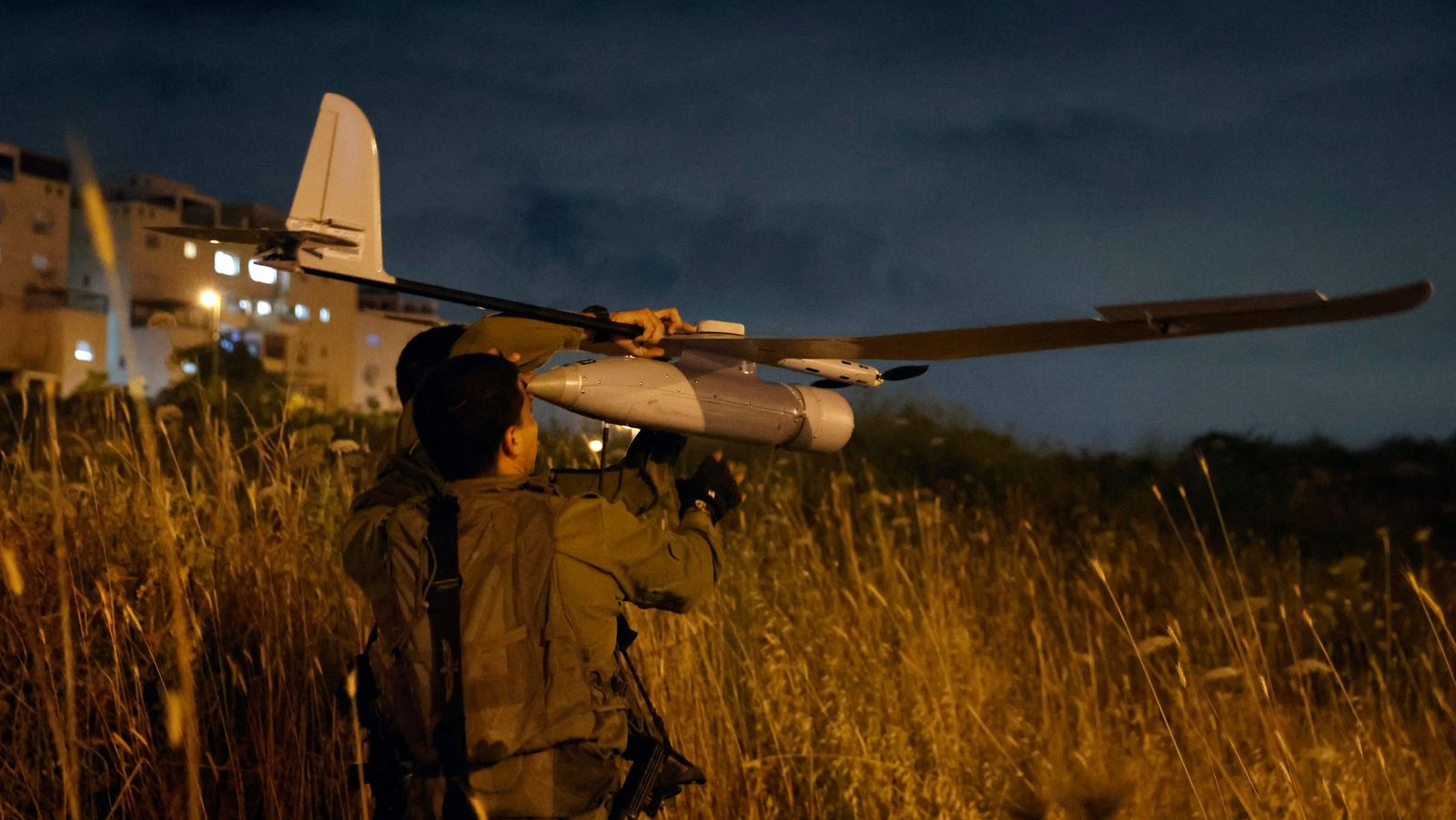 Israeli forces fly a drone to find the suspects of an attack in the central city of Elad, on May 5, 2022. - At least three people were killed in an attack in the central Israeli city of Elad as the Jewish state marked its independence day today, medics said. (Photo by JACK GUEZ / AFP) - AFP