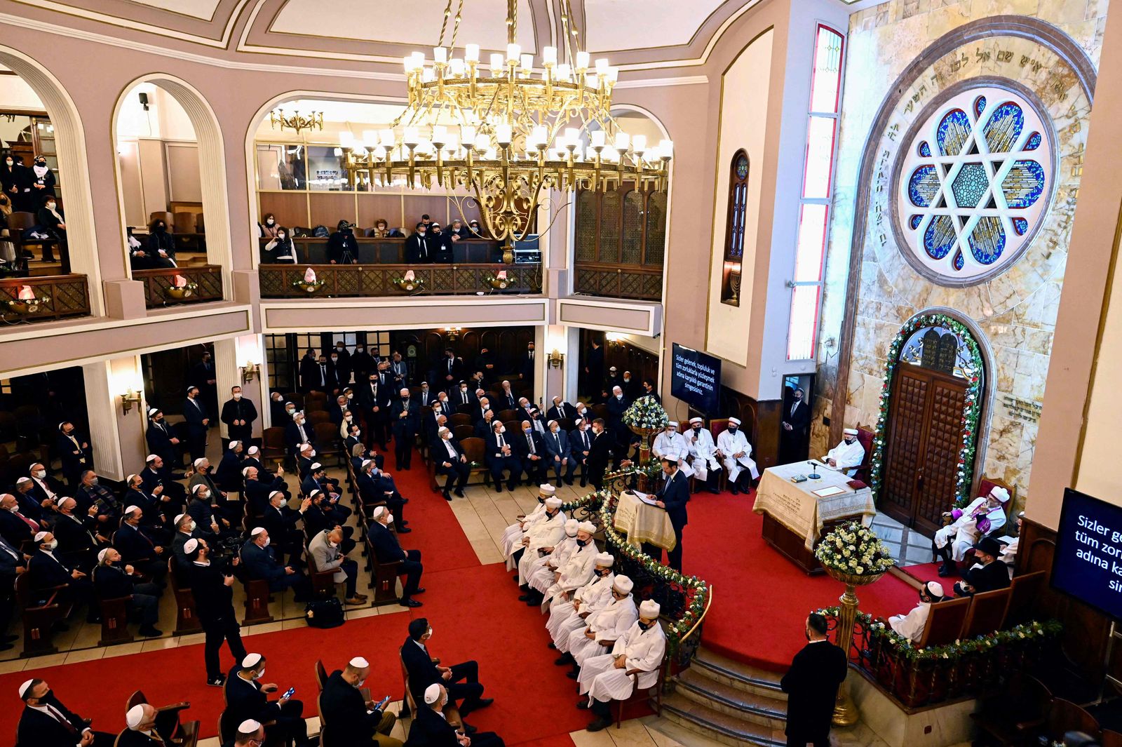 Israel's President Isaac Herzog (C) speaks as he attends a ceremony in the Neve Shalom Synagogue in Istanbul, on March 10, 2022, during a state visit to Turkey. - Israel and Turkey proclaimed a new era in relations on March 10 following more than a decade of diplomatic rupture, as the Israeli president made a landmark visit to Ankara. (Photo by Yasin AKGUL / AFP) - AFP