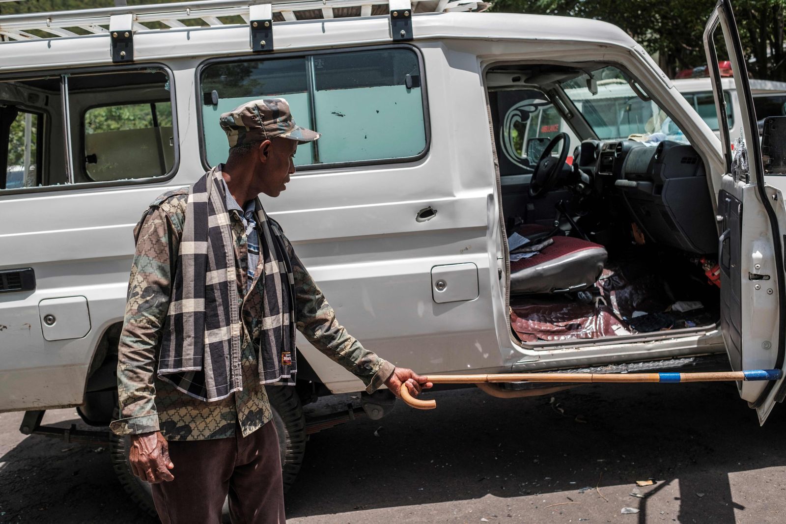 A man opens the door of a destroyed ambulance at the Ataye Primary Hospital, in Ataye, Ethiopia, on May 15, 2021. - More than 100 civilians died in a recent flare-up of violence in the town of Ataye that also saw the assailants torch more than 1,500 buildings.
The destruction continues a pattern of unrest that has blighted the tenure of Prime Minister Abiy Ahmed, winner of the 2019 Nobel Peace Prize, and now threatens to disrupt elections in which he'll seek a new term. 
Ethiopia's polls are scheduled for June 21, but officials say insecurity and logistical challenges make voting impossible -- at least for now -- in at least 26 constituencies across the country. (Photo by EDUARDO SOTERAS / AFP) - AFP