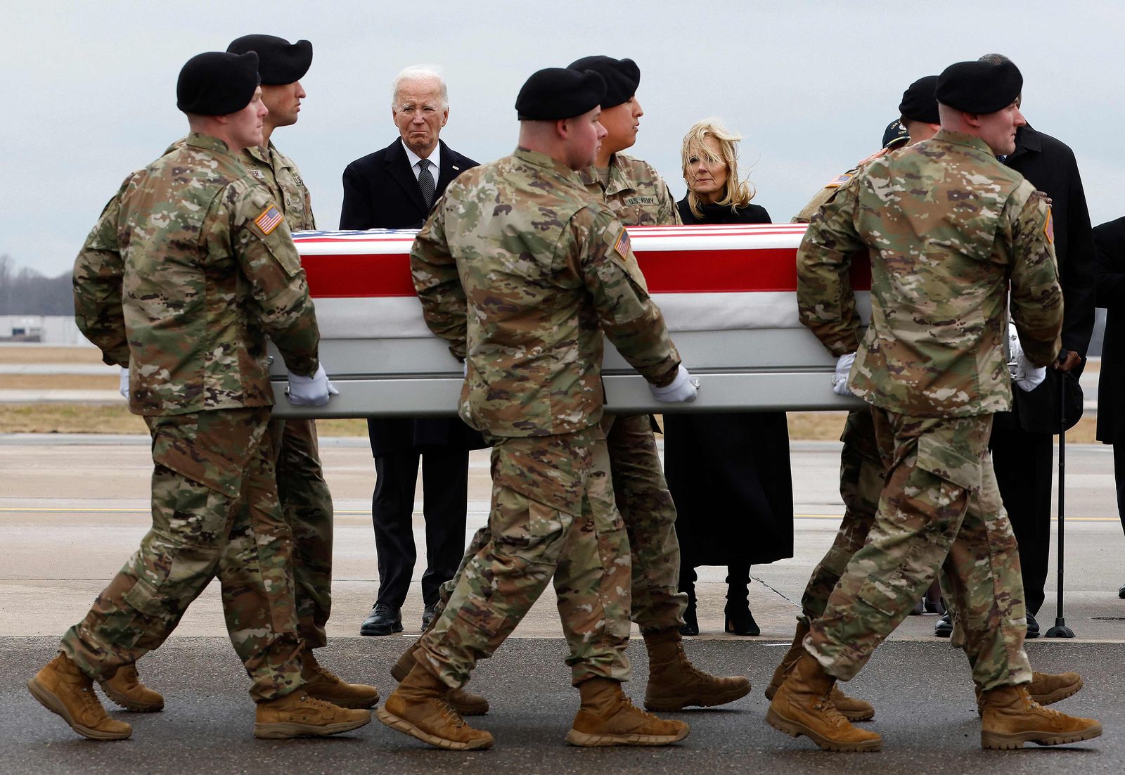 DOVER, DELAWARE - FEBRUARY 02: U.S. President Joe Biden and first lady Jill Biden pay their respects as a U.S. Army carry team moves a flagged dragged transfer case containing the remains of Army Sgt. William Rivers during a dignified transfer at Dover Air Force Base on February 02, 2024 in Dover, Delaware. U.S. Army Sgt. William Rivers, Sgt. Breonna Moffett, Sgt. Kennedy Sanders were killed in addition to 40 others troops were injured during a drone strike in Jordan.   Kevin Dietsch/Getty Images/AFP (Photo by Kevin Dietsch / GETTY IMAGES NORTH AMERICA / Getty Images via AFP)