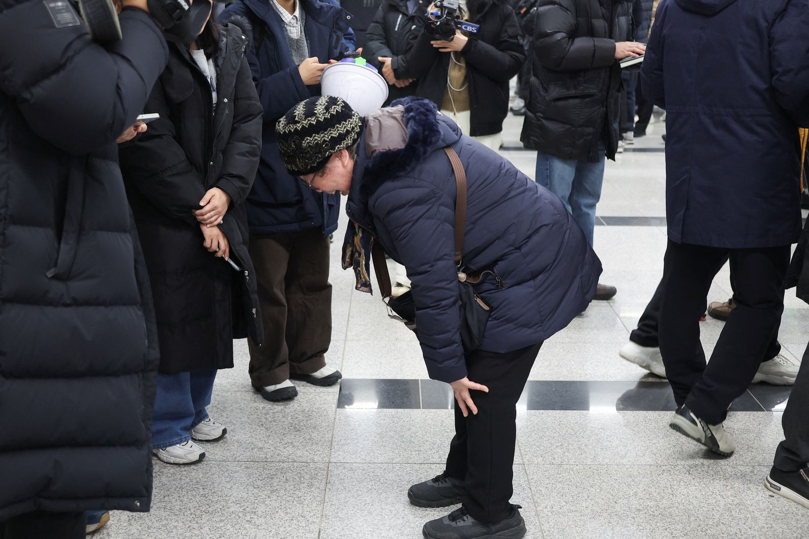 A relative of a passenger of the aircraft that crashed after it went off the runway, reacts at Muan International Airport, in Muan, South Korea, December 29, 2024. REUTERS/Kim Hong-Ji