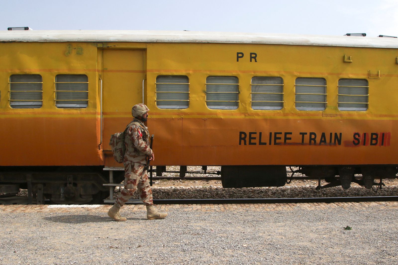 A Pakistan Army soldier walks next to a rescue train, after the attack on a train by separatist militants in Bolan, at the railway station in Mushkaf, Balochistan, Pakistan, March 12, 2025. REUTERS/Naseer Ahmed