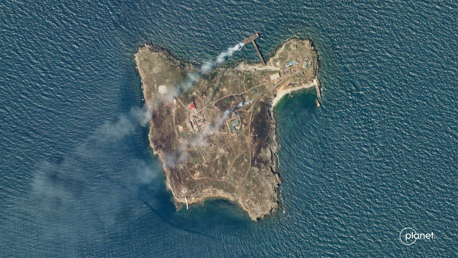 A satellite image shows smoke rising from Snake Island - via REUTERS