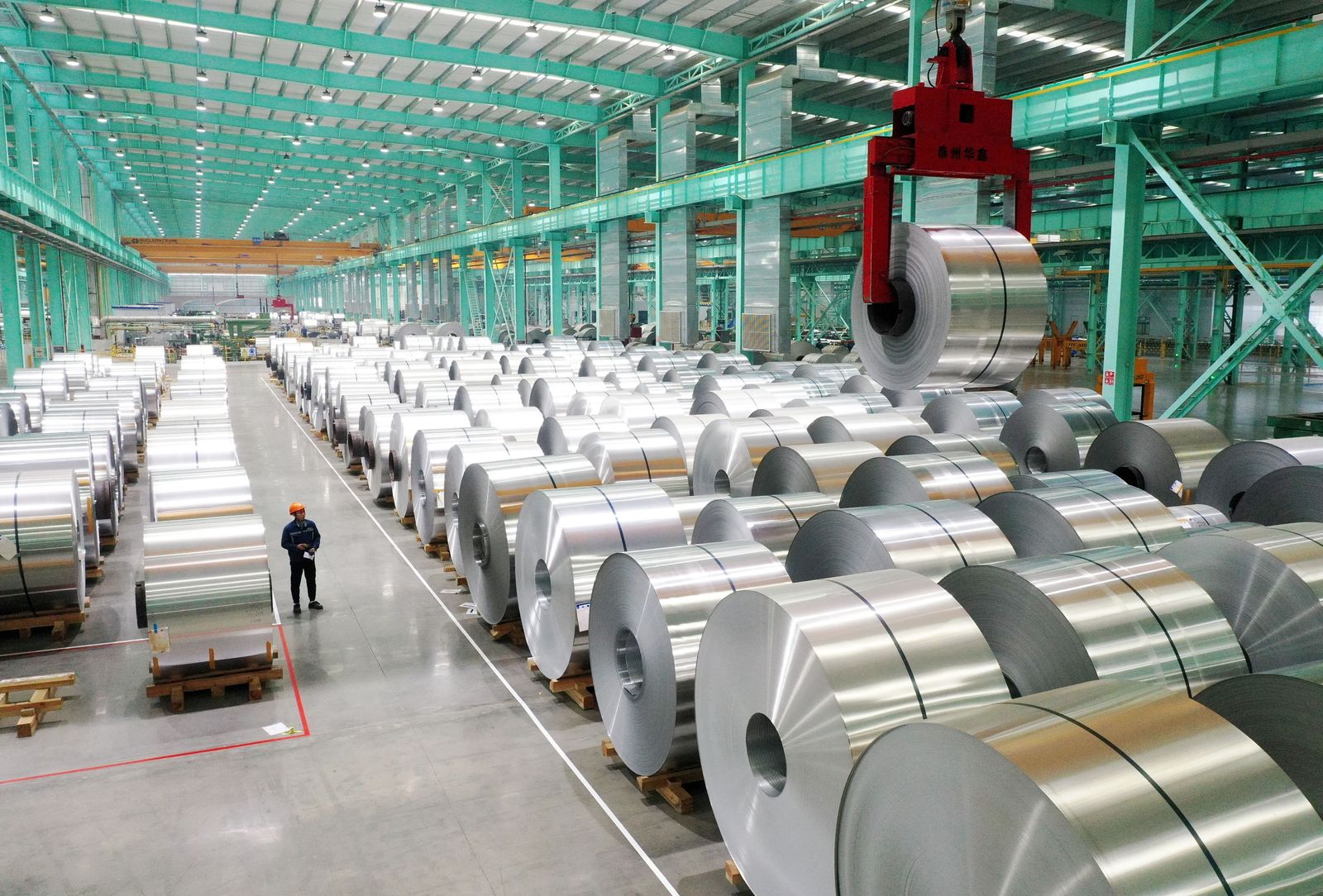 A drone view shows an employee working on the production line of aluminium products at a factory in Huaibei, Anhui province, China February 11, 2025.  China Daily via REUTERS ATTENTION EDITORS - THIS PICTURE WAS PROVIDED BY A THIRD PARTY. CHINA OUT. NO COMMERCIAL OR EDITORIAL SALES IN CHINA.