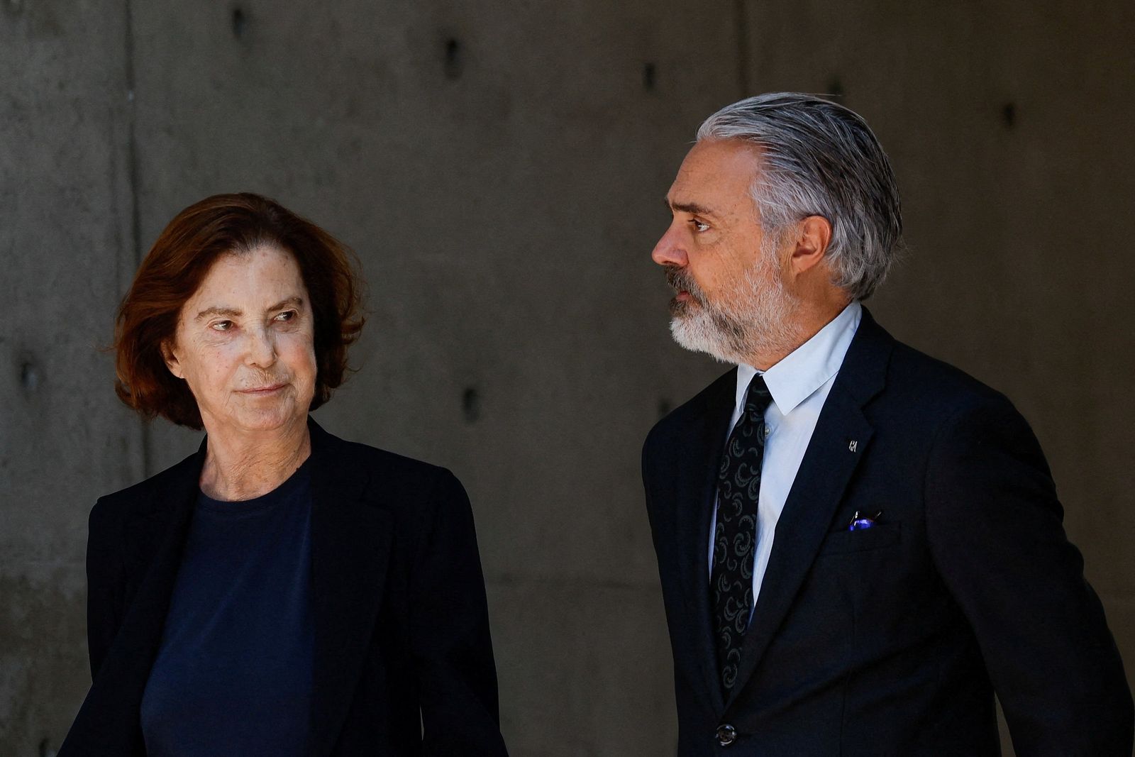 Silvana Armani and Andrea Camerana, niece and nephew of late designer Giorgio Armani, walk outside the Armani/Teatro as Armani lies in state, following his death at the age of 91, in Milan, Italy September 7, 2025. REUTERS/Remo Casilli      TPX IMAGES OF THE DAY