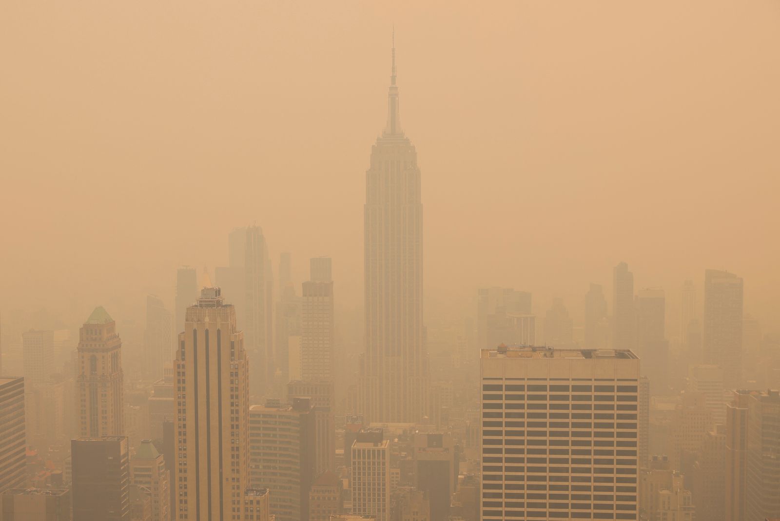 A view from the top of the Rockefeller Center, as haze and smoke caused by wildfires in Canada hang over the Manhattan skyline - REUTERS