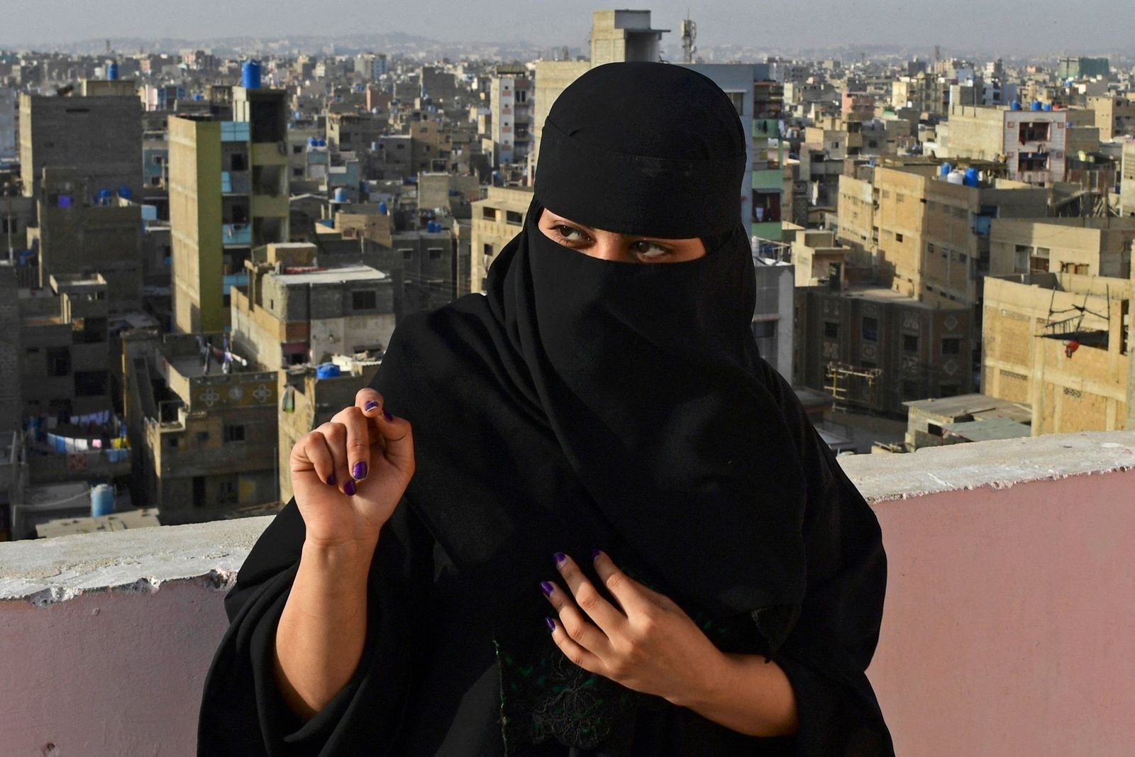 In this picture taken March 9, 2022, rapper Eva B gestures during an interview with AFP on the rooftop of a building in Lyari district in Karachi. - Pakistan's breakthrough rapper Eva B has racked up millions of views online, but walking through the labyrinthine streets of her Karachi neighbourhood, she is anonymous. (Photo by Asif HASSAN / AFP) / TO GO WITH Pakistan-women-music-EvaB,INTERVIEW by Emma Clark - AFP