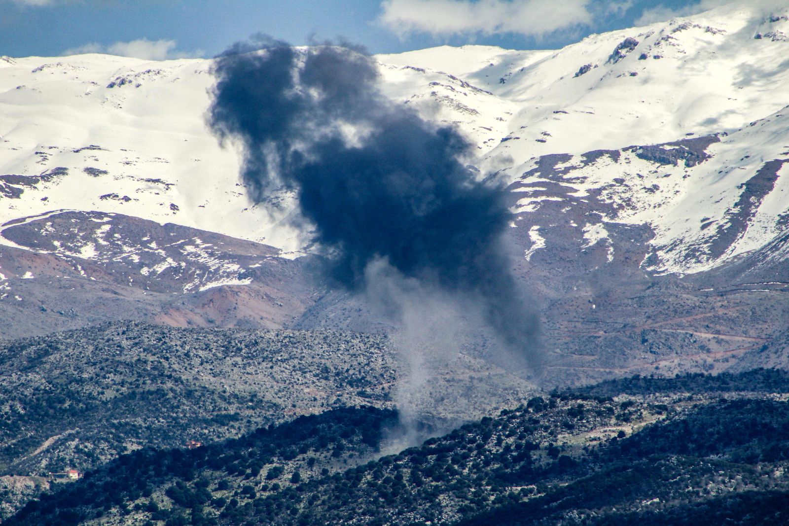 Smoke billows above hills following an Israeli strike on the Lebanese side of the disputed Shebaa Farms district in southern Lebanon on March 10, 2024, amid ongoing cross-border tensions as fighting continues between Israel and Hamas militants in the Gaza Strip. Lebanon's Hezbollah on said on March 10 it had fired dozens of rockets into northern Israel after Israeli strikes the day before left five dead in southern Lebanon, including three of the group's members. (Photo by AFP)
