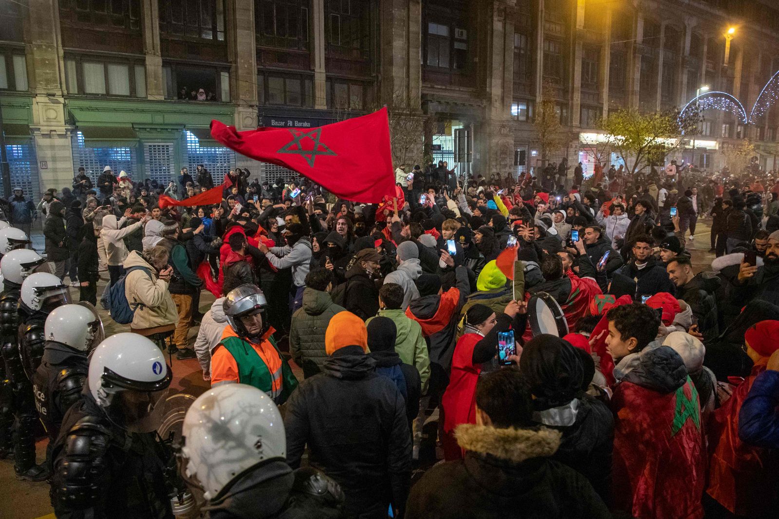 Morocco's supporters gather as they celebrate victory at the end of the Qatar 2022 World Cup quarter-final football match between Morocco and Portugal, in Brussels on December 10, 2022. - Morocco became the first African team ever to reach the semi-finals of the World Cup after defeating Portugal 1-0 on Saturday. (Photo by NICOLAS MAETERLINCK / BELGA / AFP) / Belgium OUT - AFP