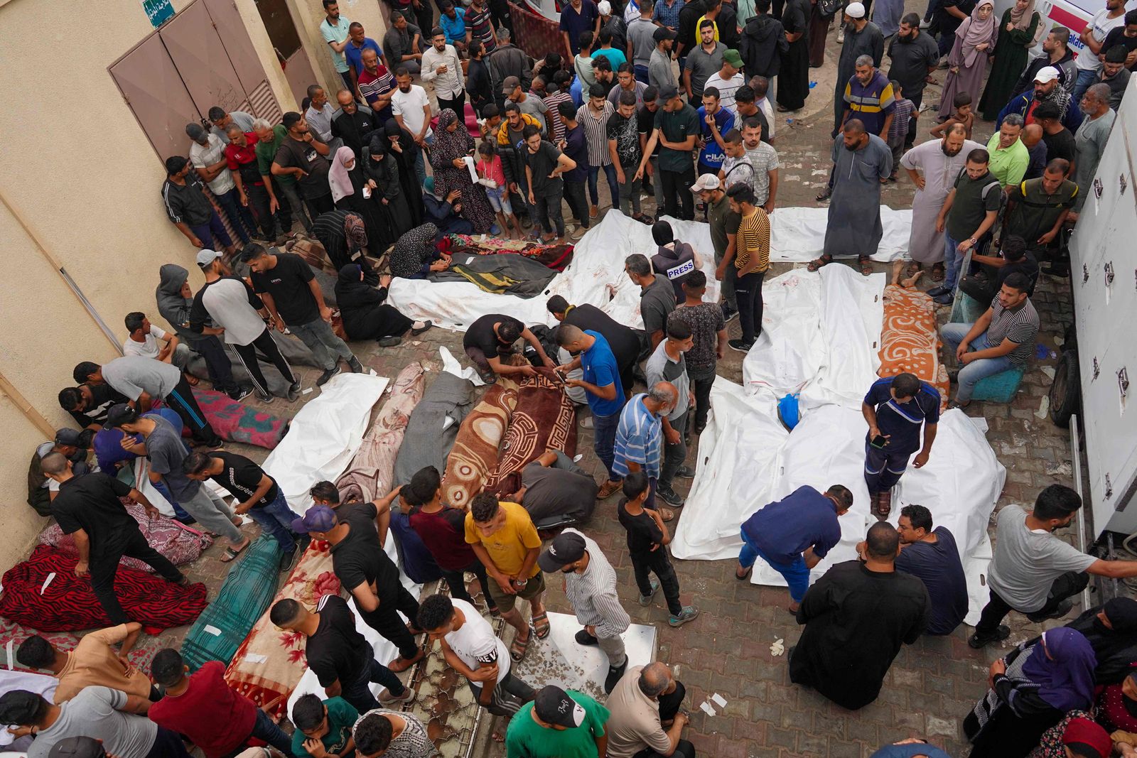 فلسطينيون يتجمعون حول جثامين ضحايا غارة جوية إسرائيلية على مدرسة تابعة للأمم المتحدة تأوي نازحين في مخيم النصيرات وسط قطاع غزة. 6 يونيو 2024