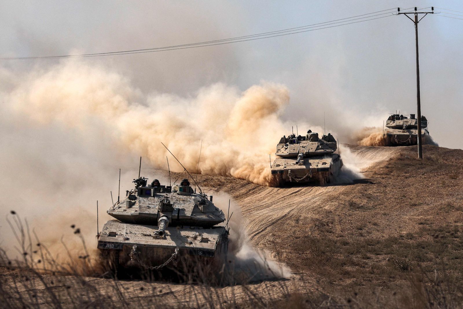 Israeli army Merkava battle tanks deploy along the border with the Gaza Strip in southern Israel on October 13, 2023. Thousands of people, both Israeli and Palestinians have died since October 7, 2023, after Palestinian Hamas militants entered Israel in a surprise attack leading Israel to declare war on Hamas in the Gaza Strip enclave on October 8. (Photo by JACK GUEZ / AFP)