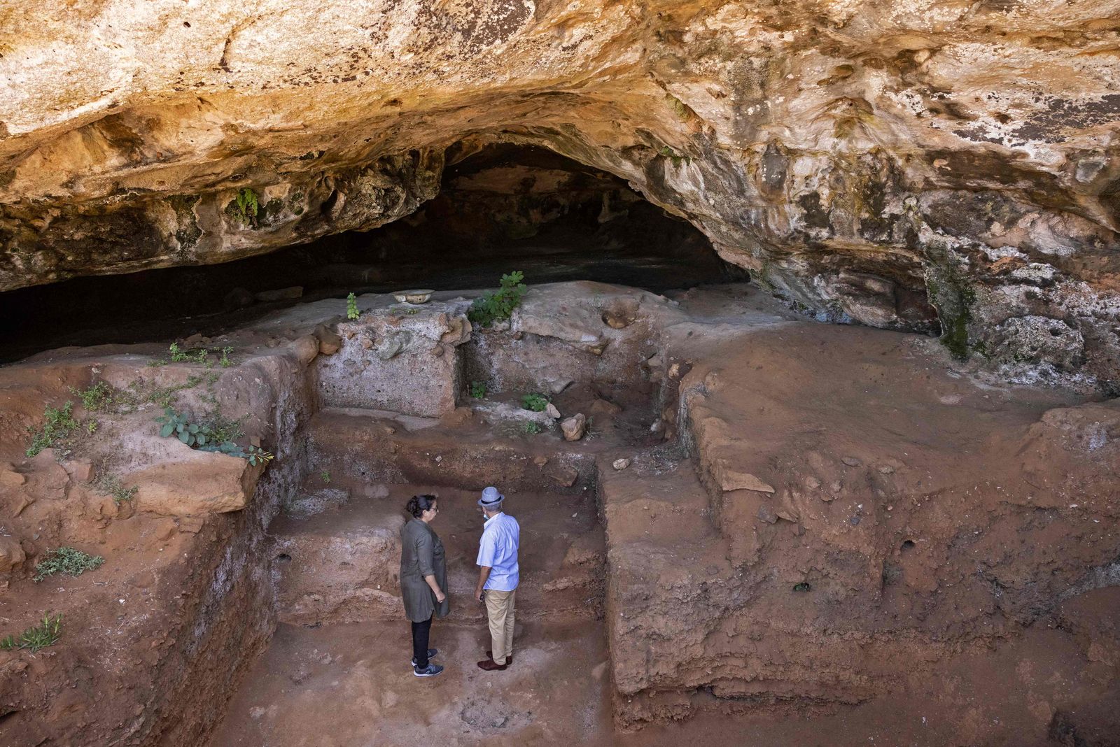 Archeologists walk to enter the Contrebandiers (Smugglers) Cave less than 20 kilometres from the Moroccan capital Rabat, on September 18, 2021. - less than 20 kilometres (12 miles) from the Moroccan capital.Archaeologists in Morocco have identified clothes-making tools fashioned from bone dating back 120,000 years, the oldest ever found, in a cave near Rabat, one of the researchers said. (Photo by FADEL SENNA / AFP) - AFP