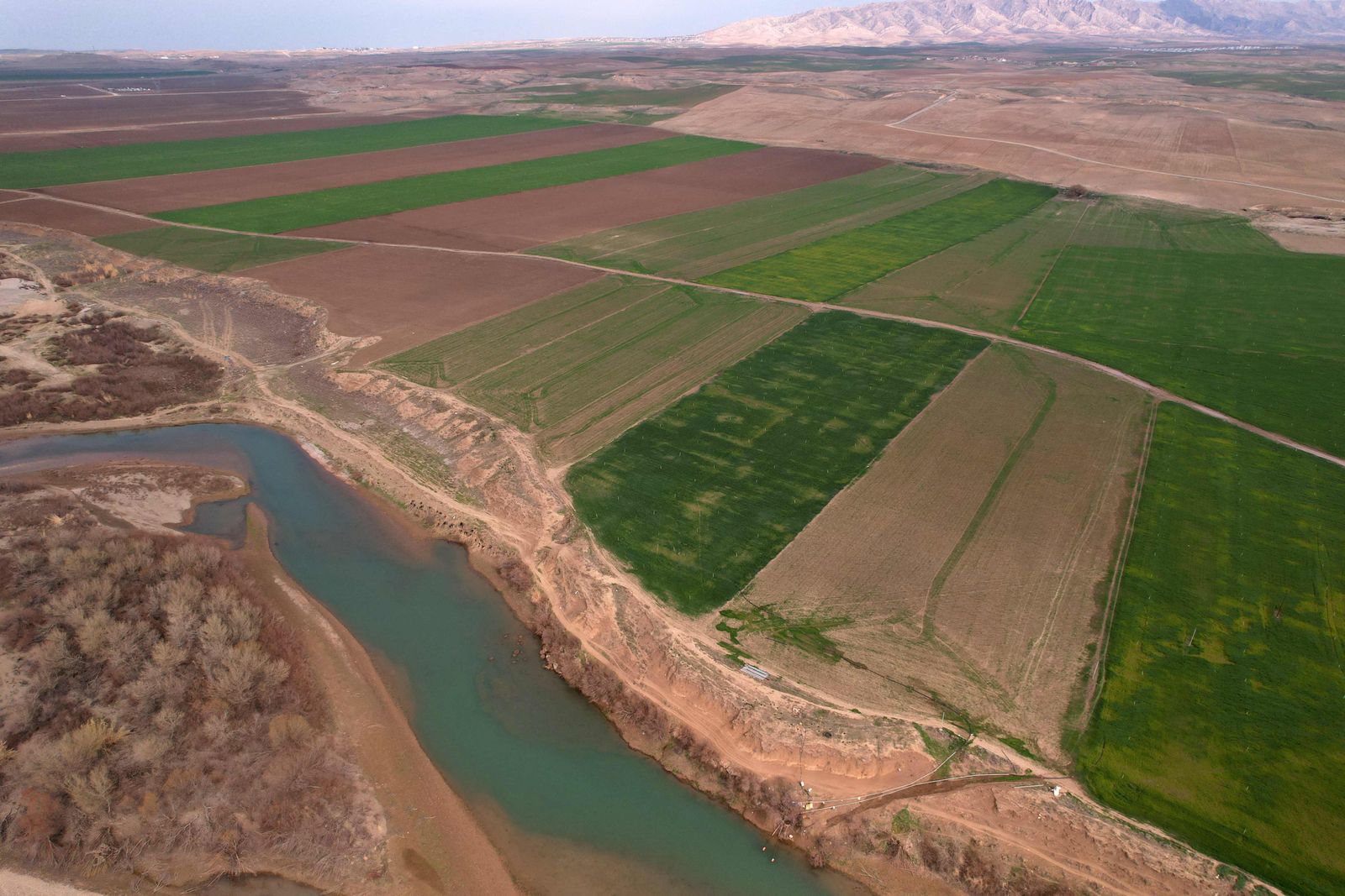 This aerial picture shows a view of the Tigris river, in the village of Bajid Kandala, some 50km west of the northern Iraqi city of Dohuk, on February 18, 2022. - The Tigris is one of Iraq's two big rivers that gave birth to the ancient empires of Sumer and Babylonia and are said to have watered the biblical Garden of Eden. Today, it is dying.Human activity and climate change have choked the once mighty stream that, with its twin the Euphrates, brought to life the civilisations of Mesopotamia thousands of years ago. (Photo by Ismael ADNAN / AFP) - AFP