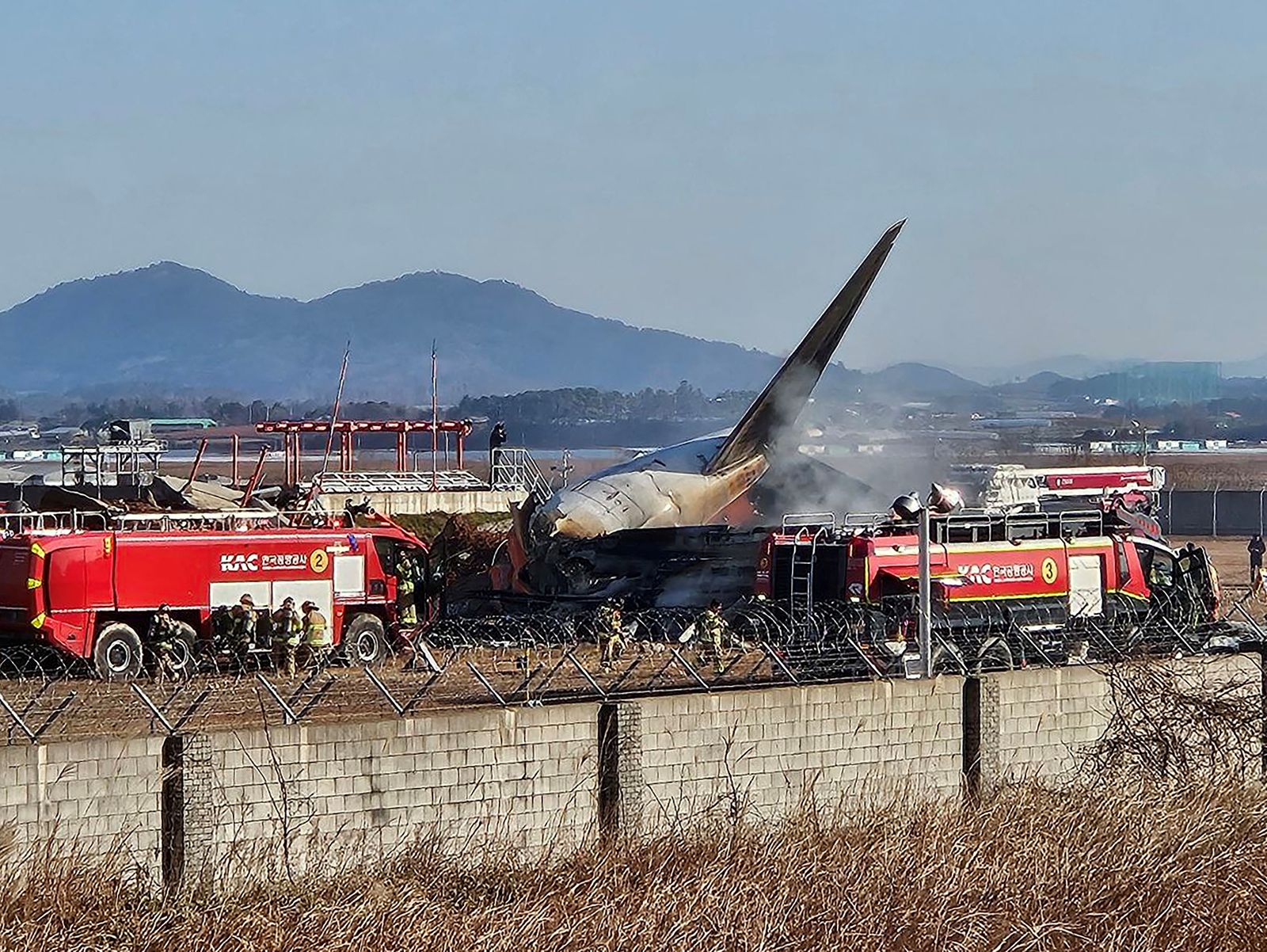 Firefighters carry out extinguishing operations on an aircraft which drove off runway at Muan International Airport in Muan, South Jeolla Province, South Korea, December 29, 2024. Yonhap via REUTERS THIS IMAGE HAS BEEN SUPPLIED BY A THIRD PARTY. NO RESALES. NO ARCHIVES. SOUTH KOREA OUT. NO COMMERCIAL OR EDITORIAL SALES IN SOUTH KOREA.