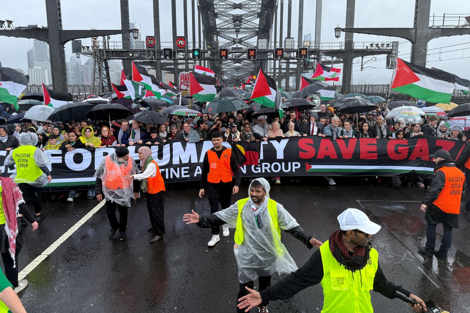 Protesters walk across the Sydney Harbour Bridge during the Palestine Action Group's March for Humanity in Sydney, Australia August 3, 2025. AAP/Dean Lewins via REUTERS    ATTENTION EDITORS - THIS IMAGE WAS PROVIDED BY A THIRD PARTY. NO RESALES. NO ARCHIVE. AUSTRALIA OUT. NEW ZEALAND OUT. NO COMMERCIAL OR EDITORIAL SALES IN NEW ZEALAND. NO COMMERCIAL OR EDITORIAL SALES IN AUSTRALIA.