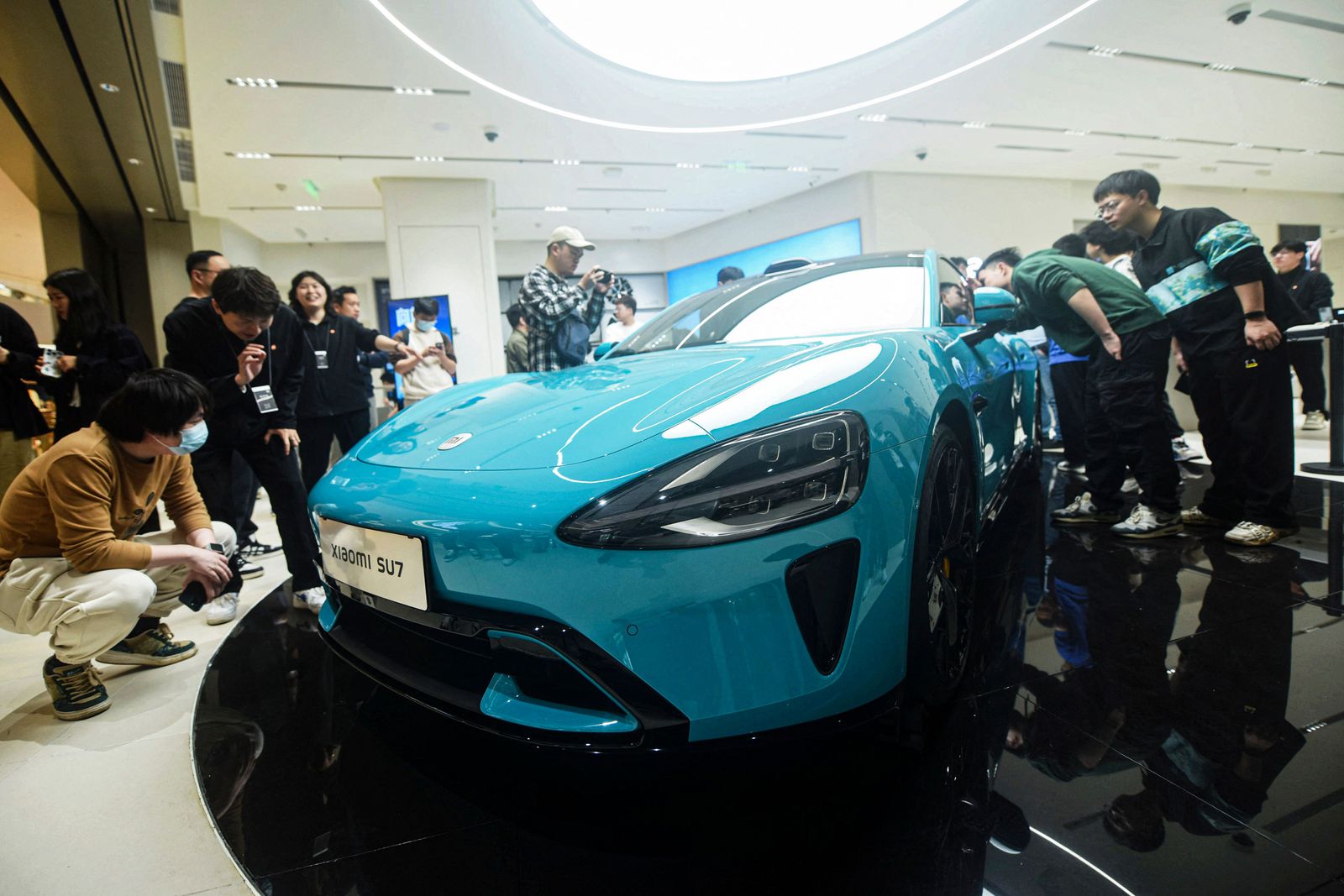 Chinese smartphone maker Xiaomi's first electric car, Xiaomi SU7 model, is seen at a shop in Hangzhou, in eastern China's Zhejiang province on March 25, 2024. (Photo by AFP) / China OUT