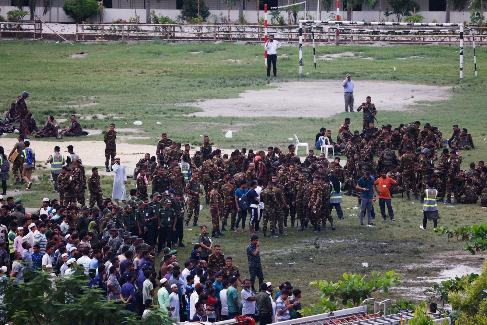 Security forces gather on the premises, after an air force training aircraft crashed into Milestone College campus, in Dhaka, Bangladesh, July 21, 2025. REUTERS/Mohammad Ponir Hossain