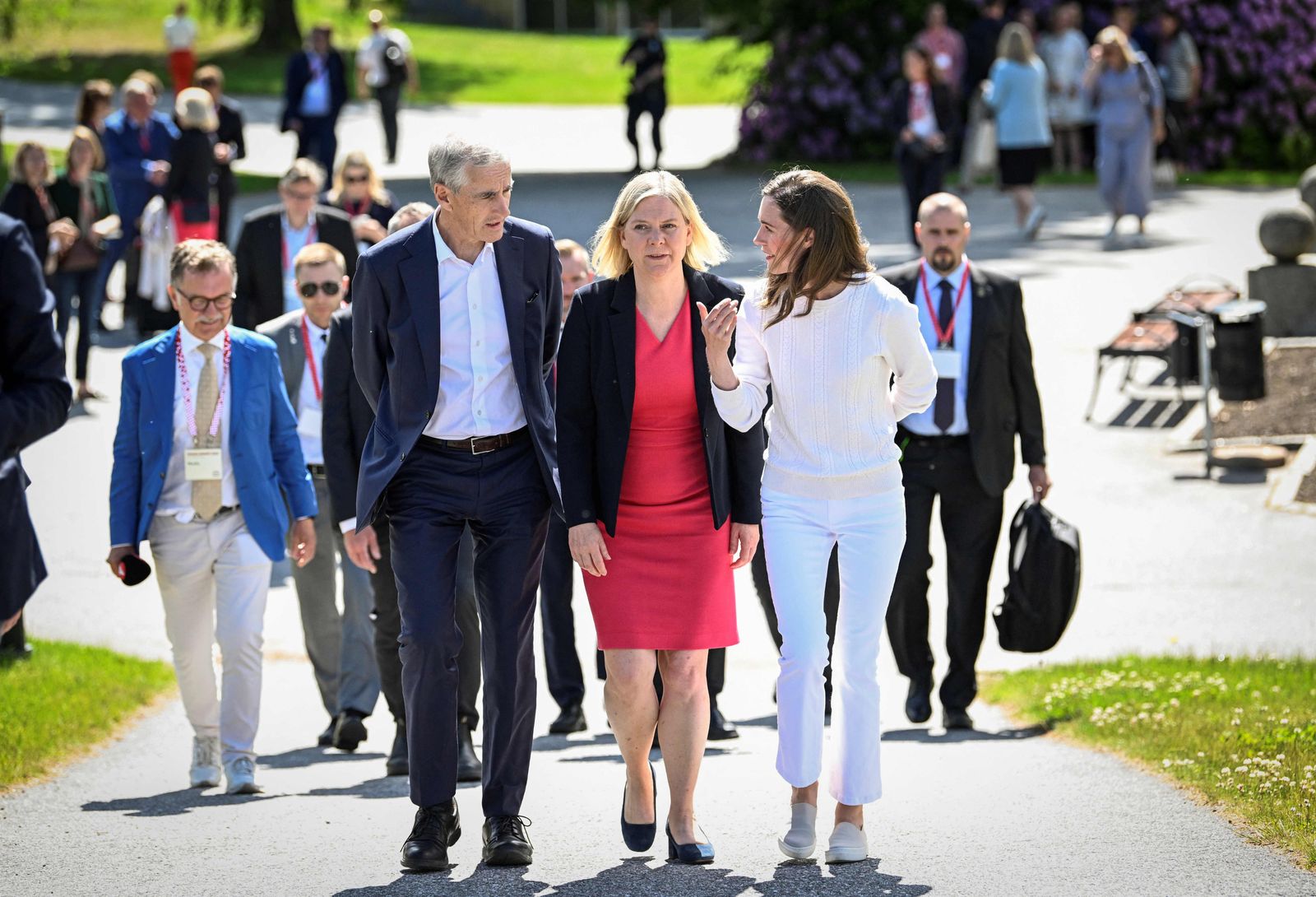 Finland's Prime Minister Sanna Marin (R), Sweden's Prime Minister Magdalena Andersson and Norway's Prime Minister Jonas Gahr Store chat as they are on their way to attend the SAMAK's summit titled 