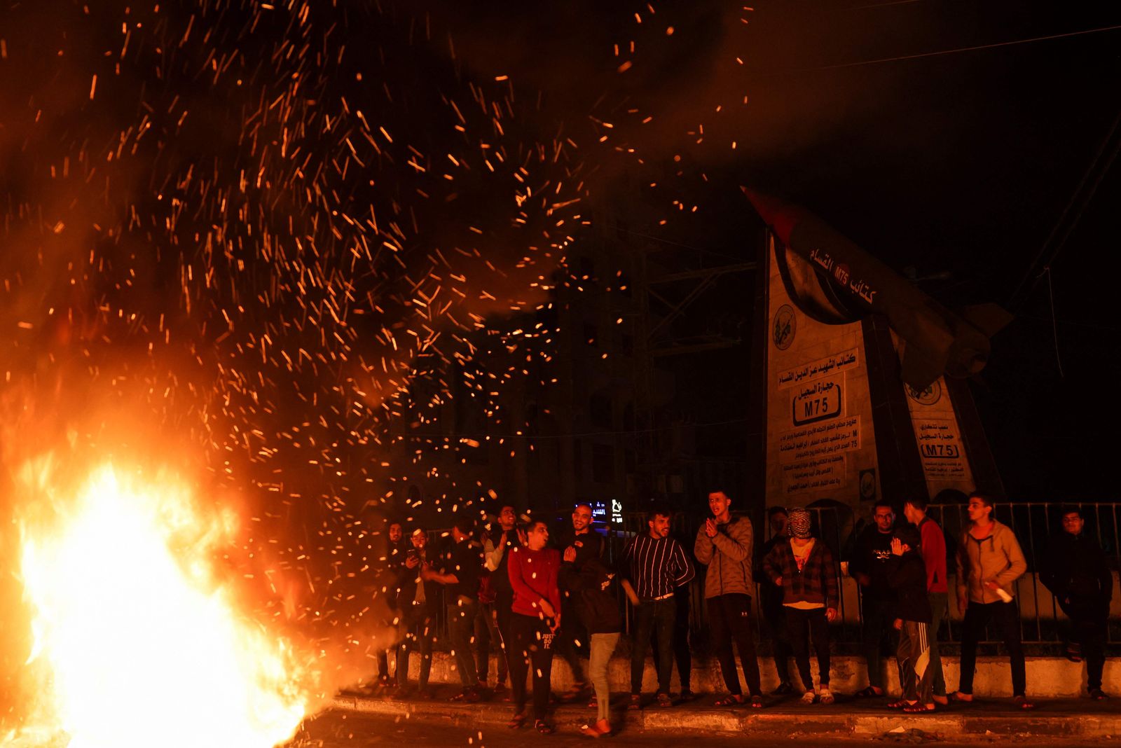 Palestinian youth react as they burn tires during a protest on the streets of Gaza City on April 5, 2023. - After the announcement of the clashes at Al-Aqsa mosque in Jerusalem early on April 5, 2023, several rockets were fired from the northern Gaza Strip towards Israeli territory, according to AFP journalists and witnesses.
AFP journalists said they saw three rockets fired from afar and witnesses said they saw others, while the Israeli army reported rocket warning sirens had been triggered in several Israeli urban centres around the Gaza Strip. (Photo by MOHAMMED ABED / AFP) - AFP