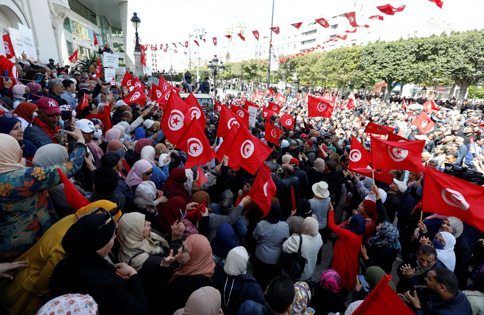 متظاهرون يرفعون لافتات وأعلام خلال مظاهرة ضد الرئيس التونسي قيس سعيد بعد أن حل البرلمان، في تونس العاصمة. 10 أبريل 2022. - REUTERS