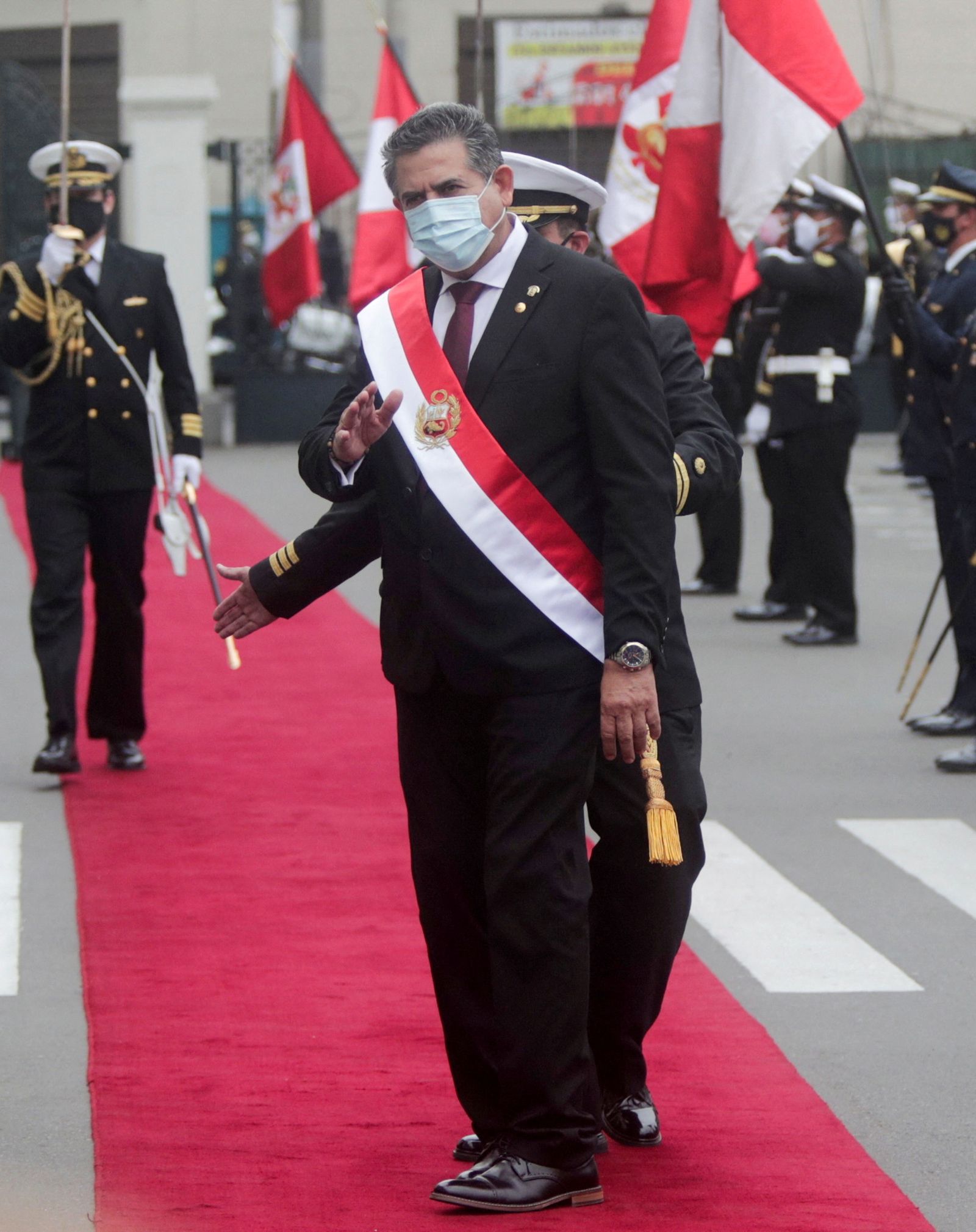 FILE PHOTO: Peru's interim President Manuel Merino gestures after he was sworn in following the removal of President Martin Vizcarra by lawmakers, in Lima - REUTERS