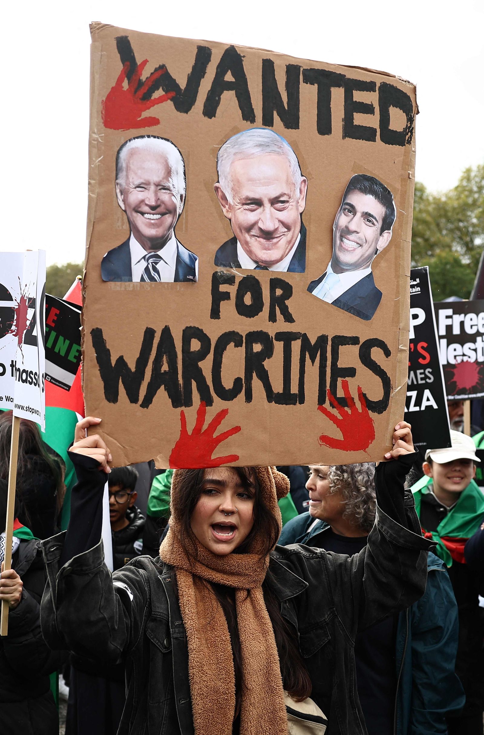 People take part in a 'March For Palestine', in London on October 21, 2023, to 'demand an end to the war on Gaza'. The UK has pledged its support for Israel following the bloody attacks by Hamas, which killed more than 1,400 people, and has announced that humanitarian aid to the Palestinians will be increased by a third -- an extra �10 million pounds ($12 million). Israel is relentlessly bombing the small, crowded territory of Gaza, where more than 3,400 people have been killed, most of them Palestinian civilians, according to the local authorities. (Photo by HENRY NICHOLLS / AFP)