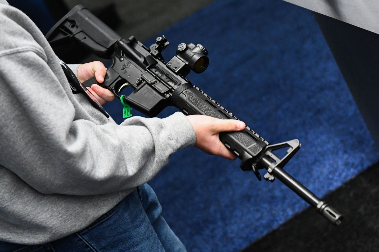 An attendee holds a Springfield Armory SAINT AR-15 style rifle displayed during the National Rifle Association (NRA) Annual Meeting at the George R. Brown Convention Center, in Houston, Texas on May 28, 2022. - America's powerful National Rifle Association kicked off a major convention in Houston Friday, days after the horrific massacre of children at a Texas elementary school, but a string of high-profile no-shows underscored deep unease at the timing of the gun lobby event. (Photo by Patrick T. FALLON / AFP) - AFP