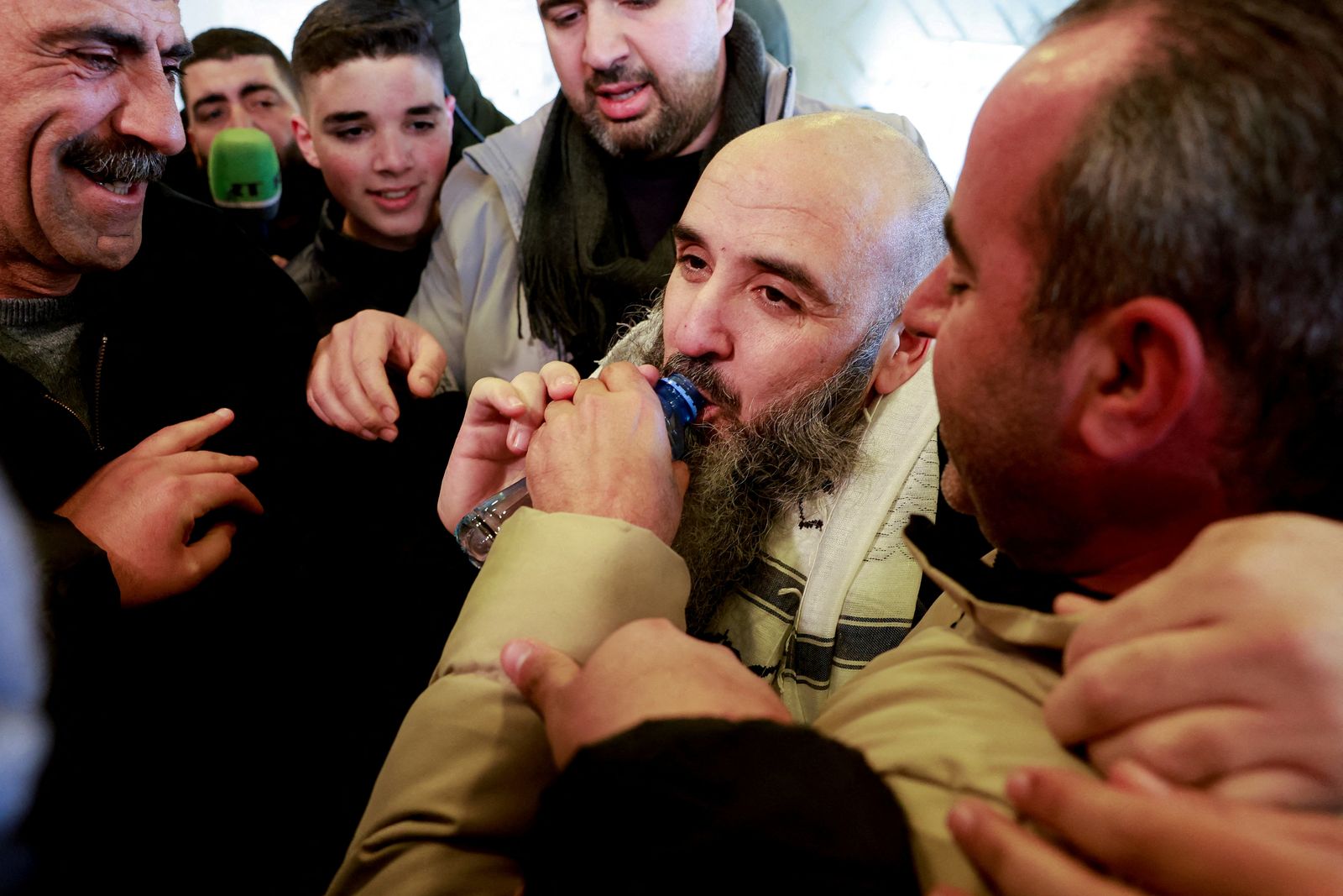 Wadah Al-Bazra, a freed Palestinian prisoner, drinks water after being released from an Israeli jail as part of a hostages-prisoners swap and a ceasefire deal in Gaza between Hamas and Israel, in Ramallah, in the Israeli-occupied West Bank, February 15, 2025. REUTERS/Ammar Awad