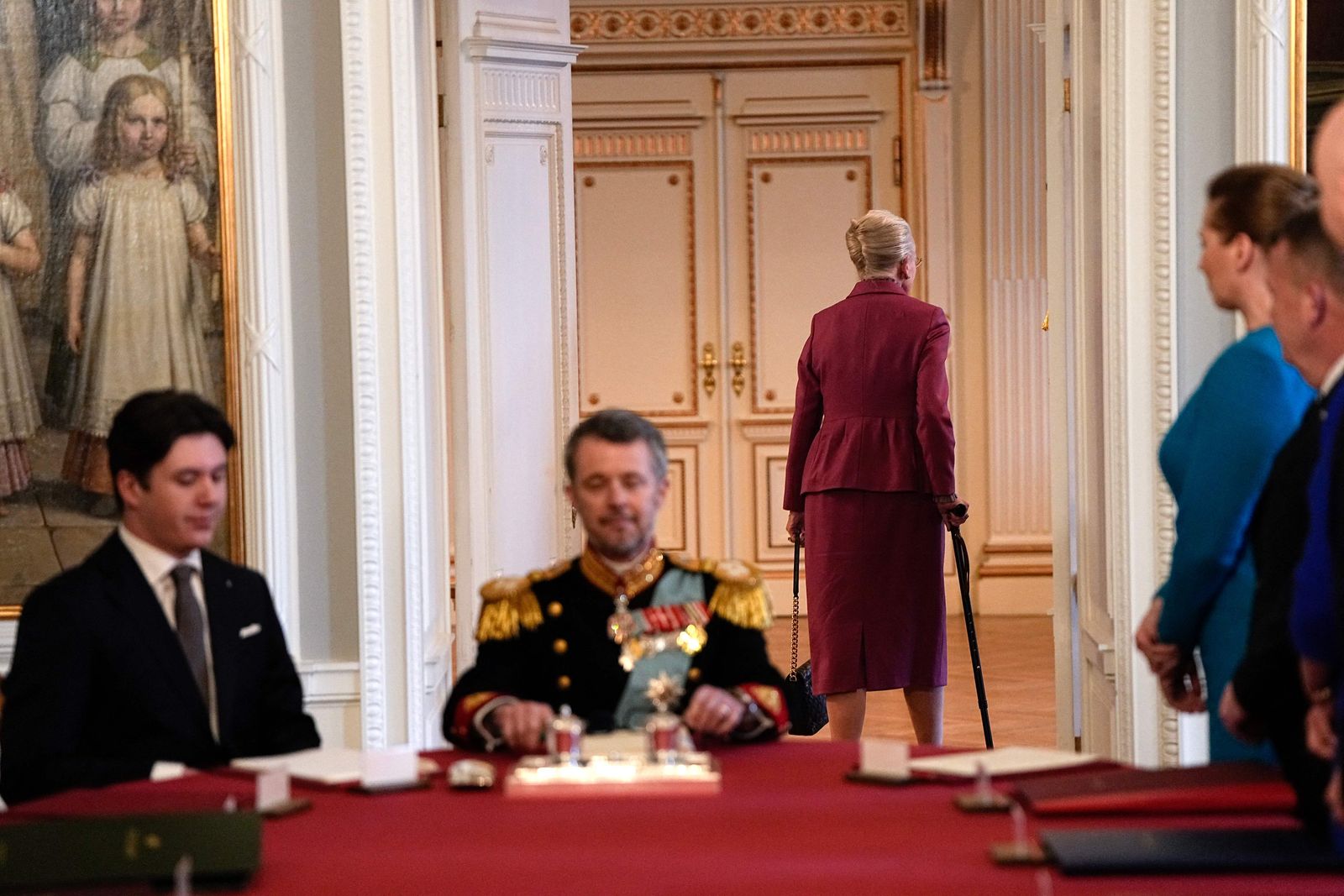 After signing the declaration of abdication Queen Margrethe II of Denmark (C-R) leaves the seat at the head of the table to her son King Frederik X of Denmark (-L) as Prince Christian of Denmark (L) and Danish Prime Minister Mette Frederiksen (R) react during the meeting of the Council of State at the Christiansborg Castle in Copenhagen, Denmark, on January 14, 2024. Denmark turns a page in its history on January 14 when Queen Margrethe abdicates and her son becomes King Frederik X, with more than 100,000 Danes expected to turn out for the unprecedented event.
The change of throne takes place during the meeting of the Council of State at the moment when the queen has signed a declaration of abdication. (Photo by Mads Claus Rasmussen / Ritzau Scanpix / AFP) / Denmark OUT