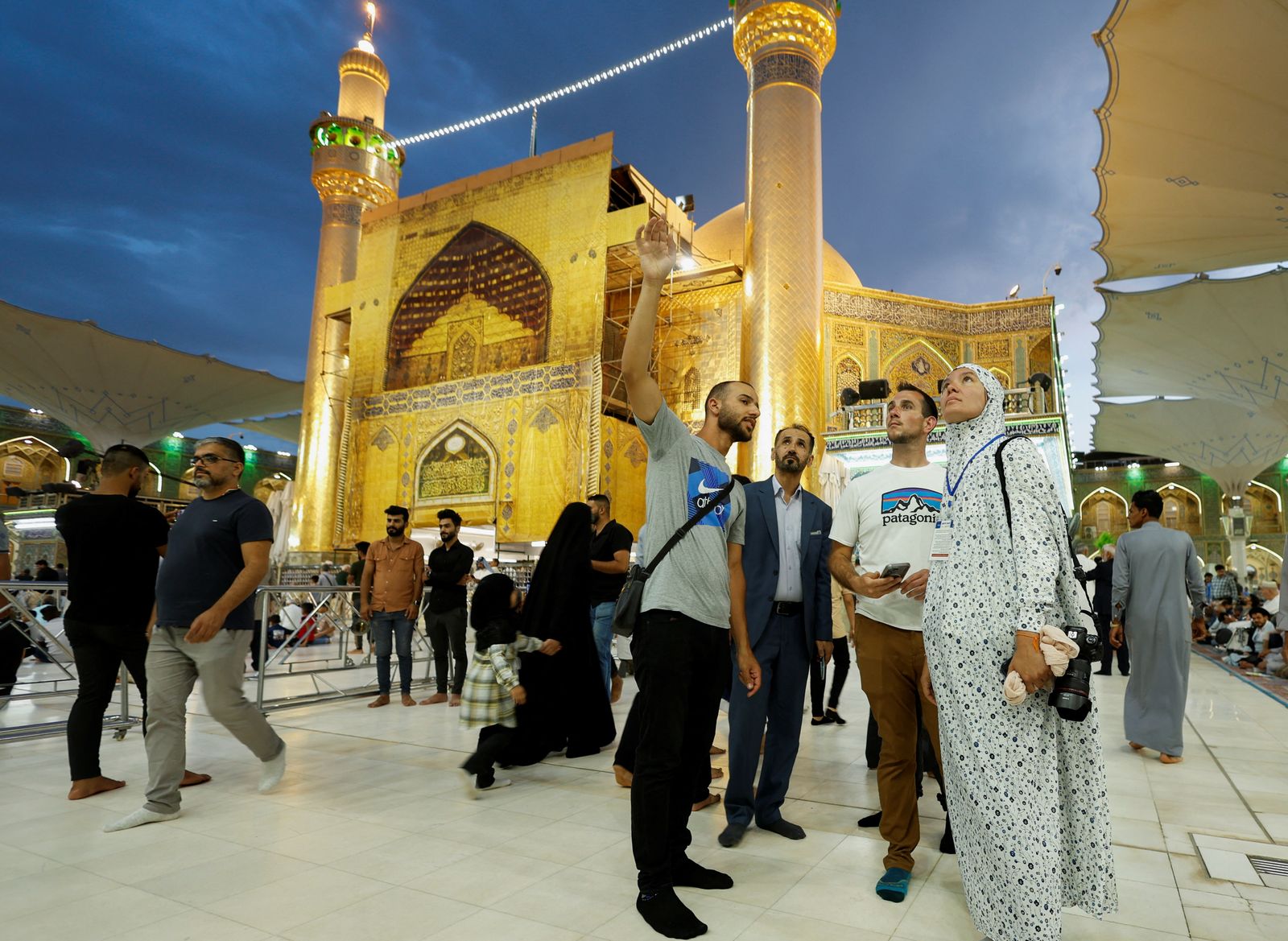 Anna Nikolaevna, 38, a Russian national, and Jacob Nemec, 29, an American national, during a tour at Imam Ali shrine, in the holy city of Najaf - REUTERS