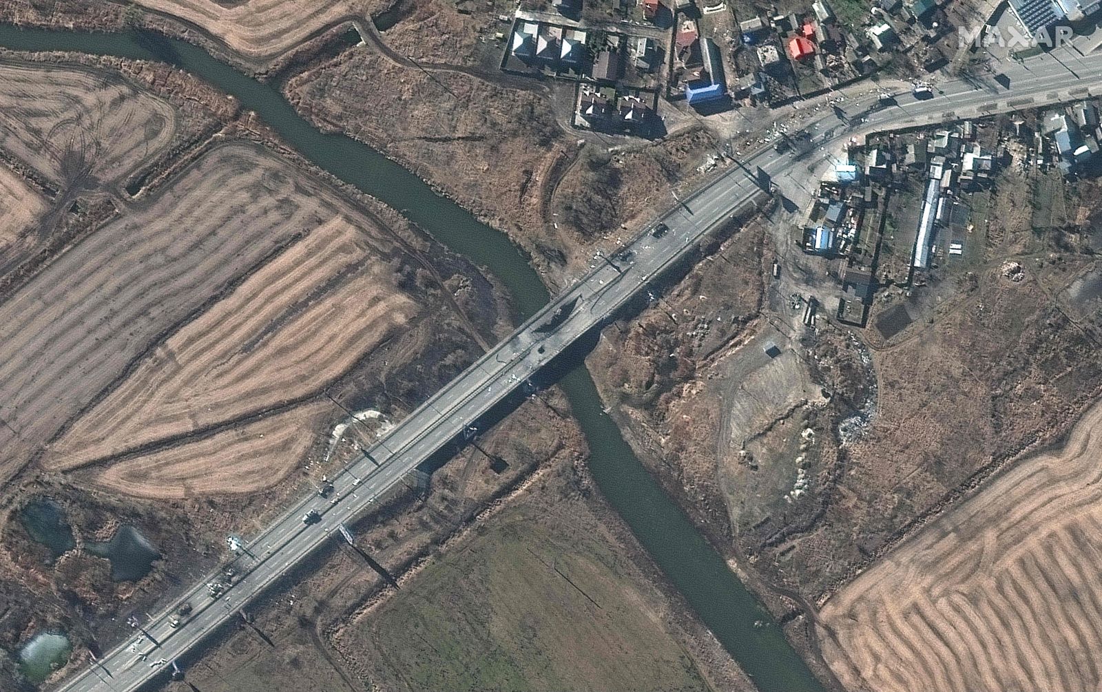 This Maxar satellite image taken and released on February 28, 2022, shows a damaged bridge and destroyed armored vehicles in Irpin, western Kyiv, Ukraine. - Traditionally neutral Switzerland will adopt all the sanctions already imposed by the EU on Russia over its invasion of Ukraine, including against President Vladimir Putin, Bern said on February 28, 2022. (Photo by Satellite image �2022 Maxar Technologies / AFP) / RESTRICTED TO EDITORIAL USE - MANDATORY CREDIT 