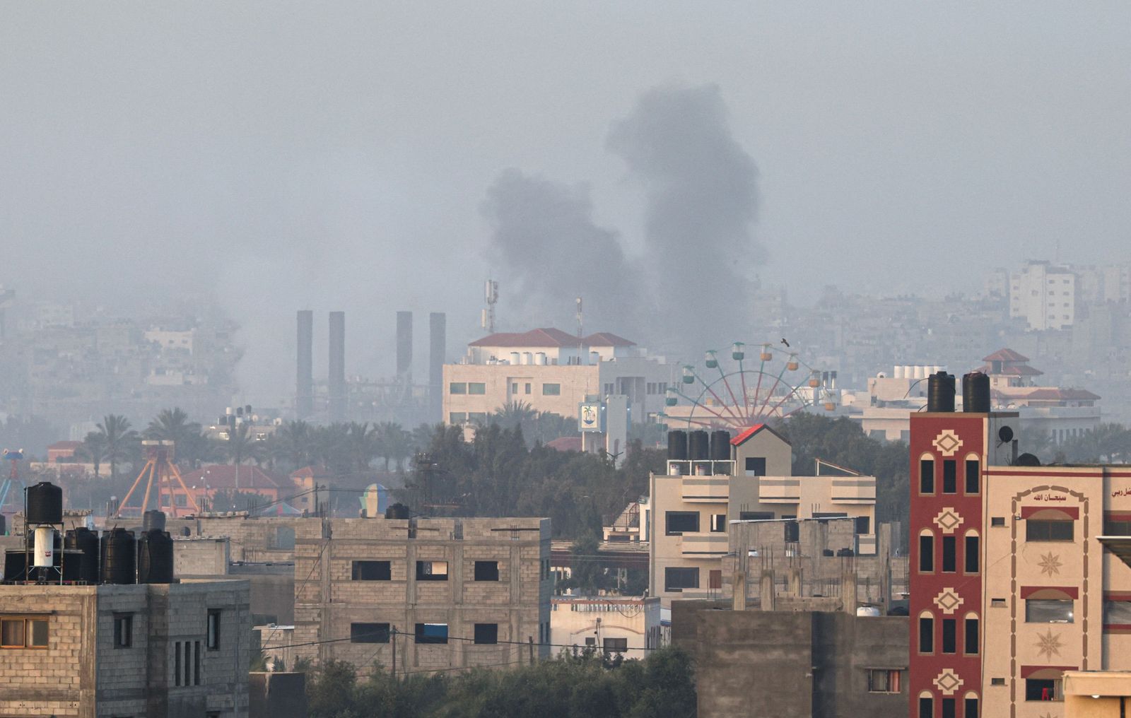 Smoke rises above buildings in Gaza City as Israel launched air strikes on the Palestinian enclave early on April 5, 2023. - After the announcement of the clashes at Al-Aqsa early on April 5, several rockets were fired from the northern Gaza Strip towards Israeli territory, according to AFP journalists and witnesses. The Israeli army said five rockets fired from the Gaza Strip were intercepted by the aerial defence system around Sderot in southern Israel, and that four others had fallen in uninhabited areas. Israeli fighter jets later struck two Hamas weapons manufacturing sites in the central Gaza Strip 