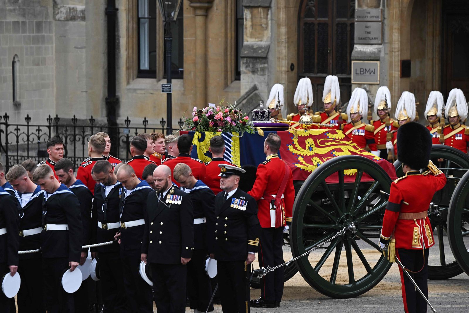 A Bearer Party of The Queen's Company, 1st Battalion Grenadier Guards carries the coffin of Queen Elizabeth II, draped in the Royal Standard and adorned with the Imperial State Crown and the Sovereign's orb and sceptre into Westminster Abbey for the State Funeral Service for Britain's Queen Elizabeth II, in London on September 19, 2022. - Leaders from around the world will attend the state funeral of Queen Elizabeth II. The country's longest-serving monarch, who died aged 96 after 70 years on the throne, will be honoured with a state funeral on Monday morning at Westminster Abbey. (Photo by Oli SCARFF / AFP) - AFP