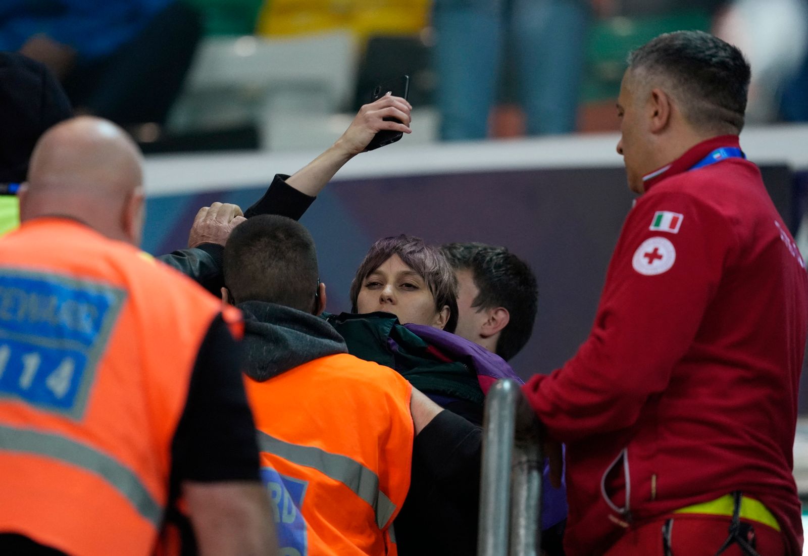 Soccer Football - FIFA World Cup - UEFA Qualifiers - Group I - Italy v Israel - Bluenergy Stadium, Udine, Italy - October 14, 2025 A protester is apprehended by security staff in the stands REUTERS/Matteo Ciambelli