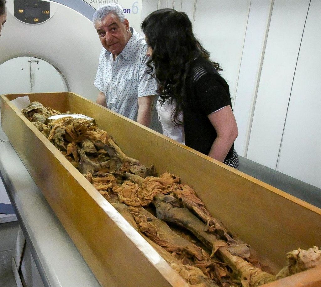 Zahi Hawass, an Egyptologist, stands next to assistant as a mummy, said to be belonging to an ancient Egyptian King, is put through a CT scanner in Egypt - VIA REUTERS