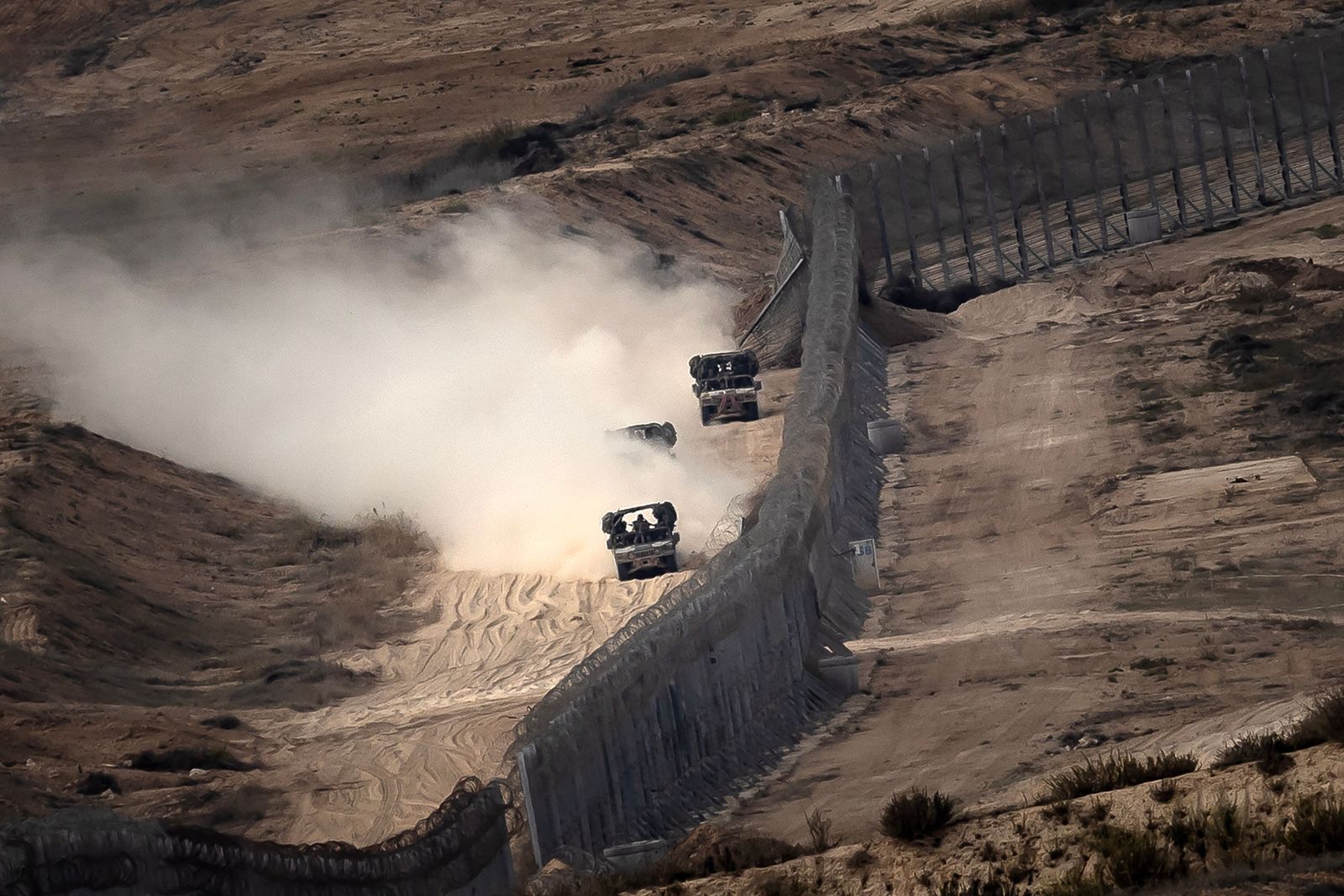 This picture taken on November 12, 2023 from a position along the border with the Gaza Strip in southern Israel shows an Israeli tank approaching the border fence inside Gaza amid ongoing battles between Israeli forces and Hamas. More than 10,000 people have been killed in relentless Israeli bombardment of the Gaza Strip, according to the Hamas-run health ministry, since the war erupted after Palestinian militants raided southern Israel on October 7 killing at least 1200 people, according to official Israeli figures. (Photo by FADEL SENNA / AFP)