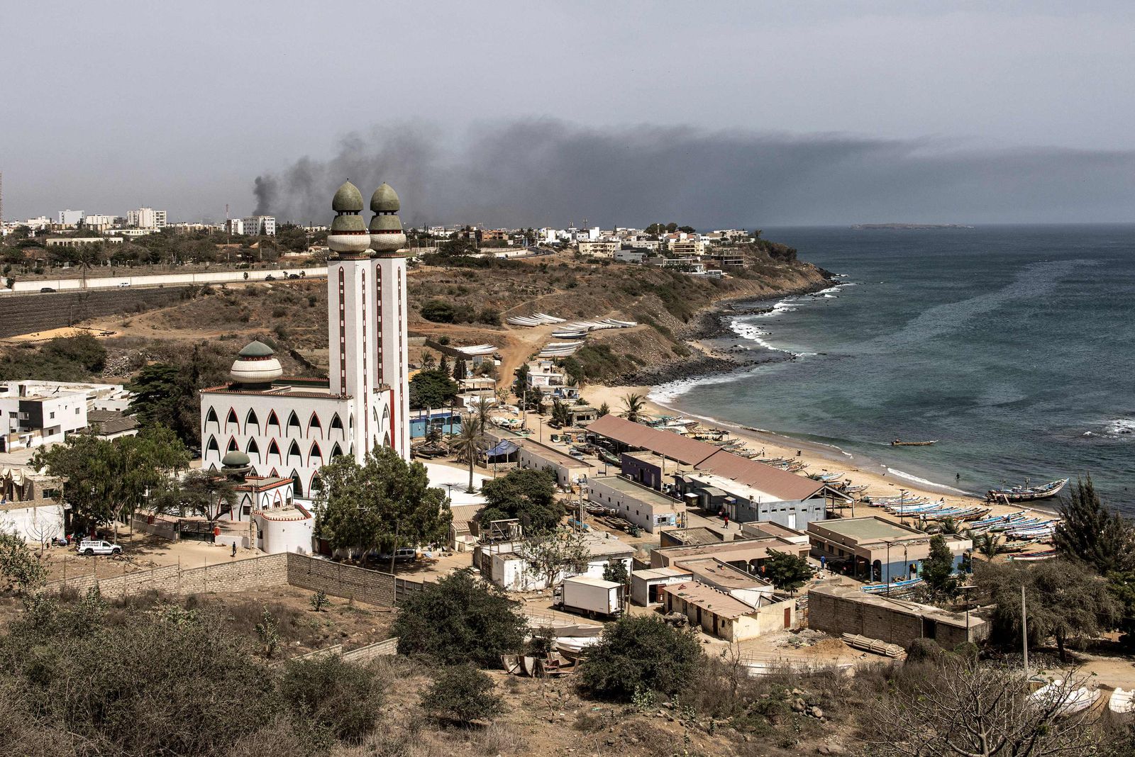 Smoke billows at the horizon in Dakar on June 1, 2023 during a protest. A court in Senegal on Thursday sentenced opposition leader Ousmane Sonko, a candidate in the 2024 presidential election, to two years in prison on charges of 