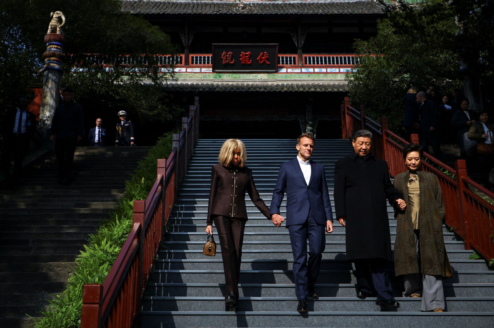 French President Emmanuel Macron, his wife Brigitte Macron, Chinese President Xi Jinping and his wife Peng Liyuan visit the Dujiangyan site, designated a UNESCO World Heritage Site, in Dujiangyan, Sichuan province, as part of a three-day visit to China, December 5, 2025. REUTERS/Sarah Meyssonnier/Pool