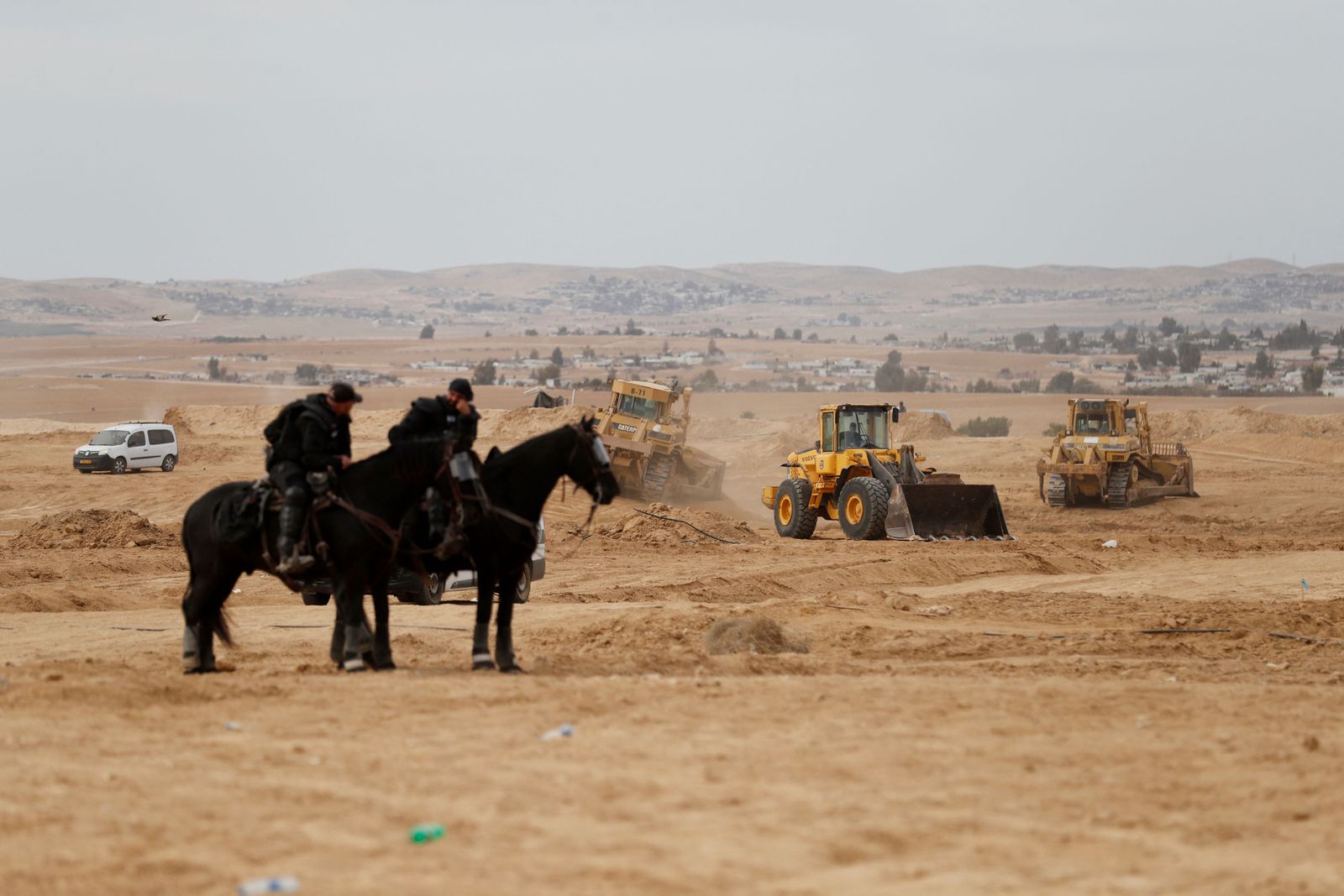 Israeli mounted police monitor the situation as Bedouins protest in the southern Israeli village of Sa�we al-Atrash in the Neguev Desert against an afforestation project by the Jewish National Fund (JNF), on January 12, 2022. (Photo by Ahmad GHARABLI / AFP) - AFP