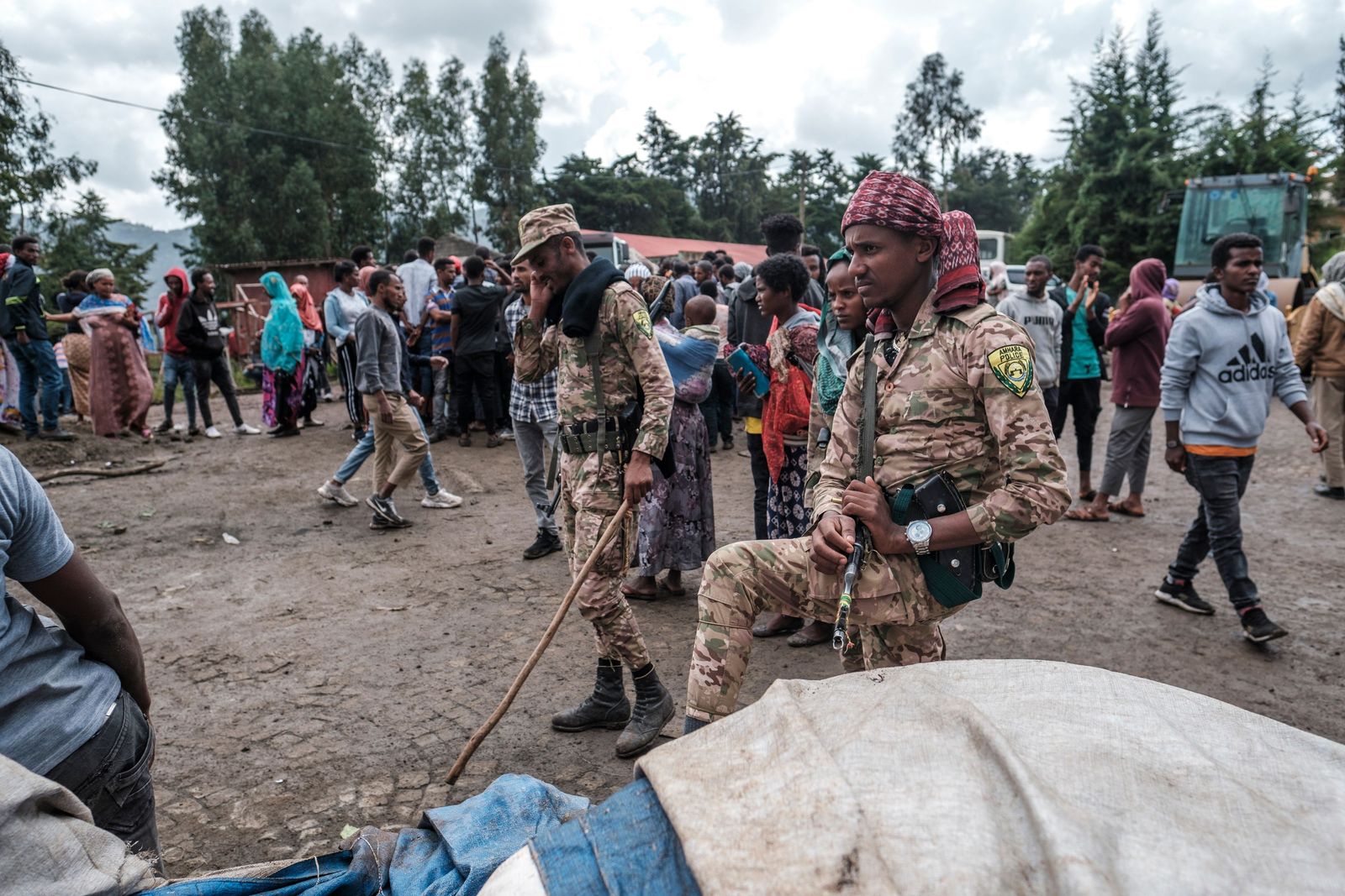 Members of Special Force of the Amhara Police stand next to sacks of food during a food distribution for internally displaced people (IDP) from Amhara region, in the city of Dessie, Ethiopia, on August 23, 2021. - Long confined to Tigray, the conflict in Ethiopia has recently spread to two neighbouring regions, Afar and Amhara, with heavy weapons fire killing an untold number of civilians and displacing hundreds of thousands more. (Photo by EDUARDO SOTERAS / AFP) - AFP