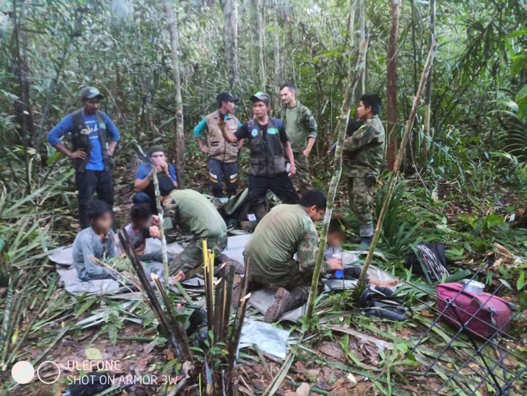 In this handout photo released by the Colombian Presidency, members of the army assist four indigenous children who were found after spending more than a month lost in the Colombian Amazon jungle following the crash of a small plane on June 9, 2023. Four Indigenous children were found alive Friday after spending more than a month lost in the Colombian Amazon rainforest following a small plane crash that triggered a massive rescue operation, the country's President Gustavo Petro said. (Photo by PRENSA PRESIDENCIA / Colombian Presidency / AFP) / RESTRICTED TO EDITORIAL USE - MANDATORY CREDIT 