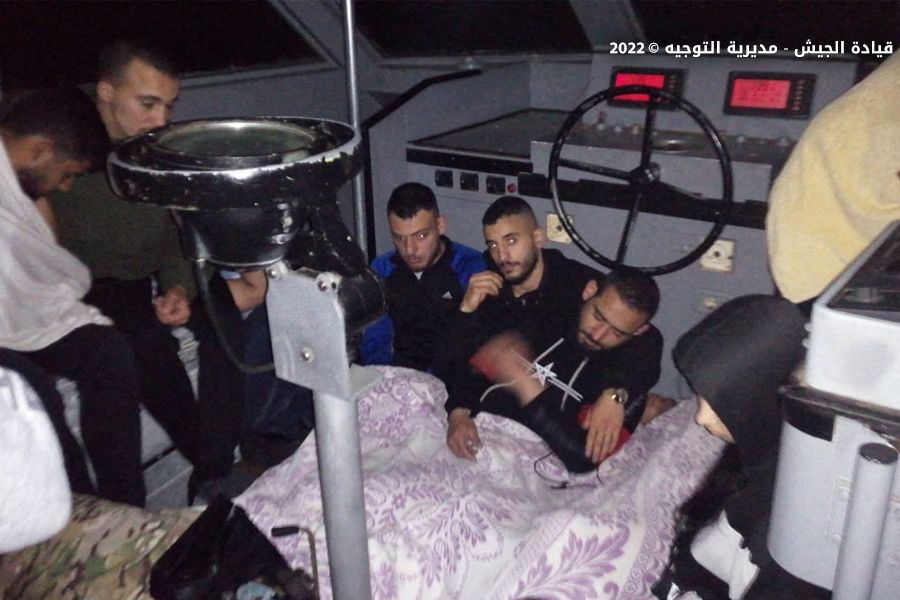 A handout photo provided by the Lebanese Army website on April 24, 2022, reportedly shows survivors of a capsized boat on board an army boat after they were rescued off the coast of the northern Lebanese city of Tripoli. - At least six people died, including a little girl, and almost 50 others were rescued after an overloaded migrant boat capsized off north Lebanon during a chase by naval forces, Lebanese officials said. The boat carrying nearly 60 people capsized on Saturday night near the port city of Tripoli, the departure point for a growing number of people attempting a potentially lethal sea escape. (Photo by Lebanese Army Website / AFP) / RESTRICTED TO EDITORIAL USE - MANDATORY CREDIT 