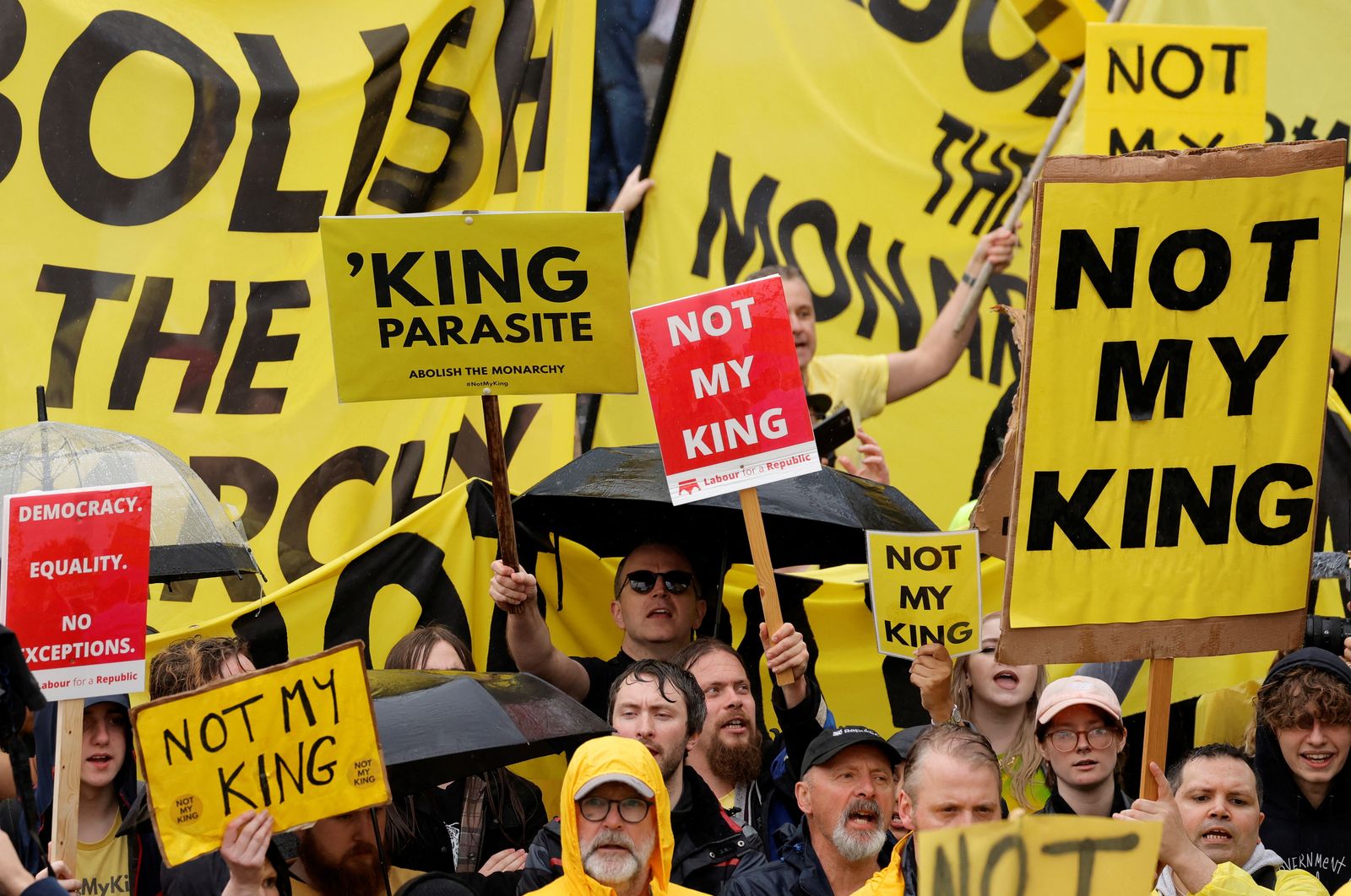 Protesters hold placards as people gather on the day of Britain's King Charles and Queen Camilla's coronation ceremony, in London, Britain May 6, 2023. REUTERS/Piroschka van de Wouw/Pool - REUTERS