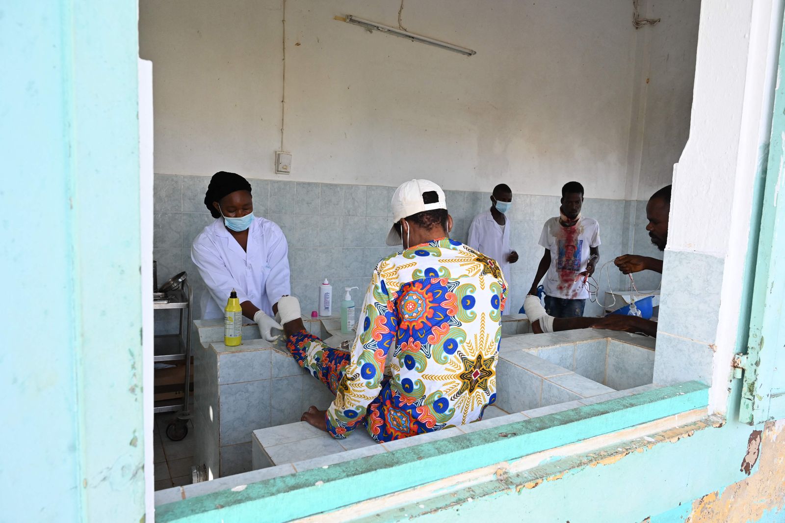 Leprosy patients are seen at at the Raoul Follereau Institute near Adzope on January 25, 2023. - Listed by the WHO as one of the 20 neglected tropical diseases (NTDs), leprosy is transmitted from a sick person to healthy person. The microbe multiplies very slowly, and the incubation period can last up to 5 years. The first symptoms show spots, then gradually eat away at desensitized limbs. (Photo by Issouf SANOGO / AFP) - AFP