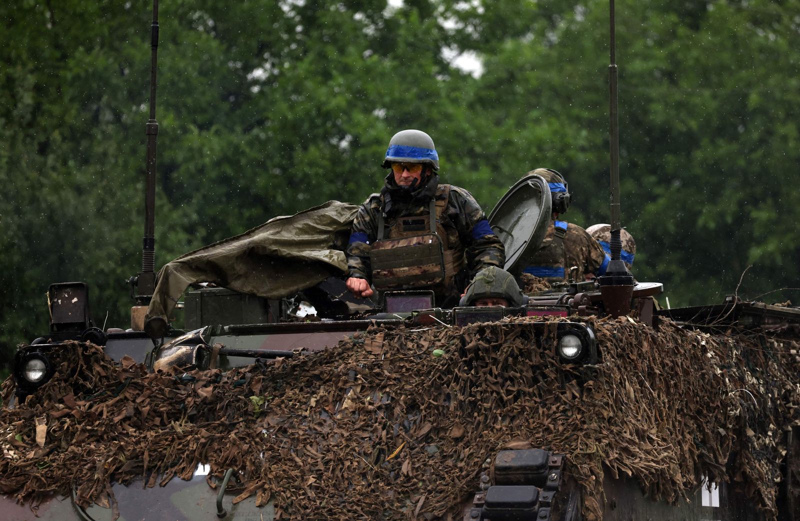 Ukrainian servicemen ride atop an armoured personnel carrier vehicle (APC) in the Zaporizhzhya region on June 11, 2023. (Photo by Anatolii Stepanov / AFP) - AFP