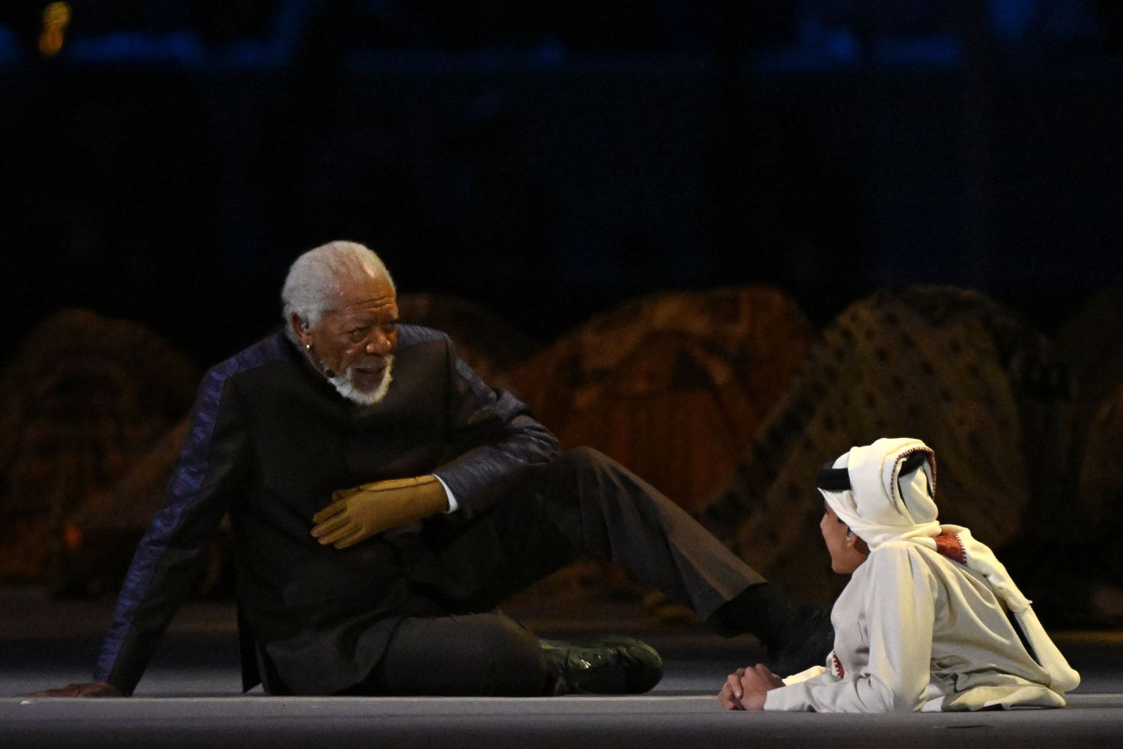 US actor Morgan Freeman (L) and Qatari YouTuber Ghanim al-Muftah speak during the opening ceremony of the Qatar 2022 World Cup Group A football match between Qatar and Ecuador at the Al-Bayt Stadium in Al Khor, north of Doha, on November 20, 2022. (Photo by Raul ARBOLEDA / AFP) - AFP