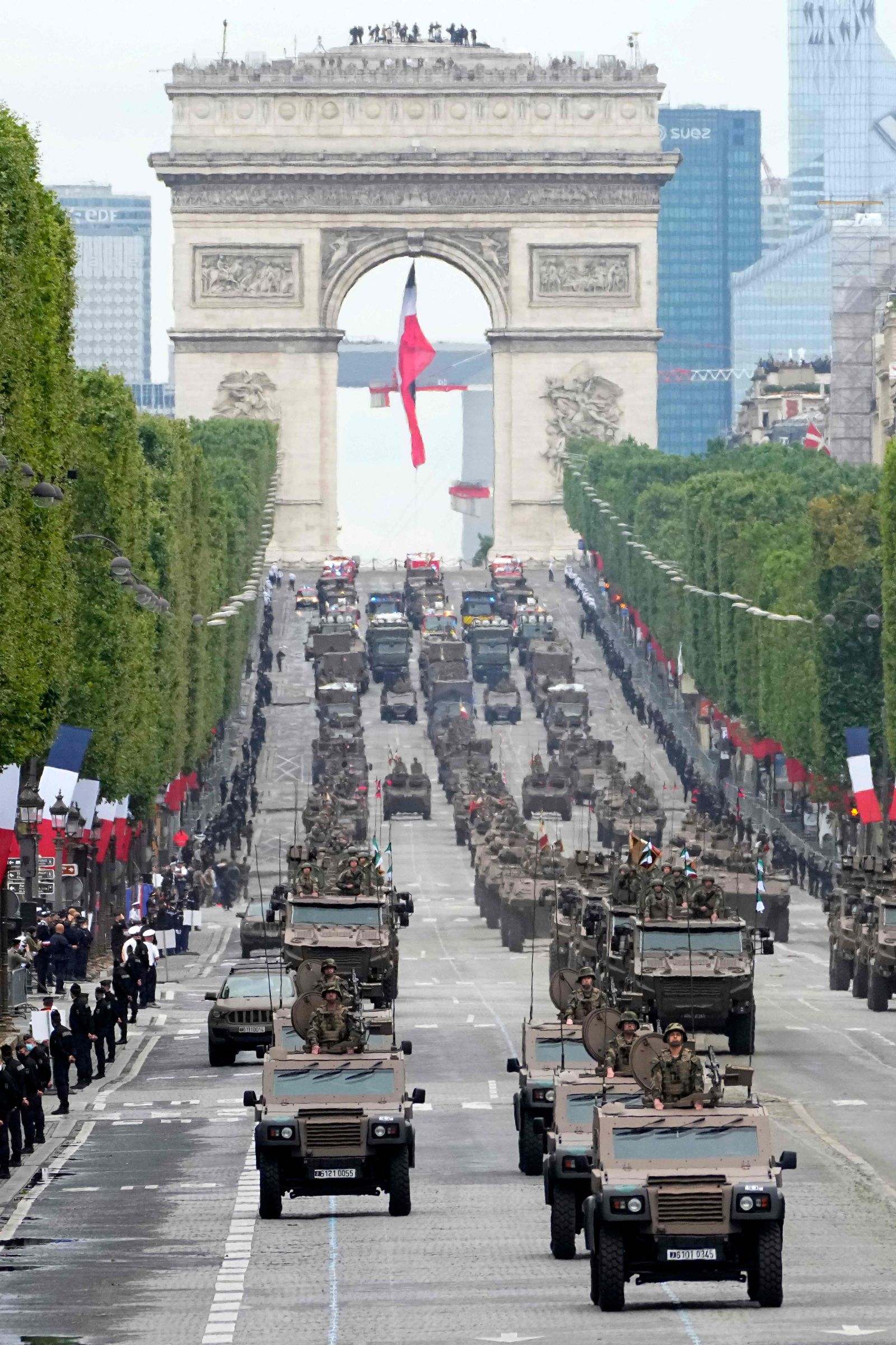 Armored vehicles drive down on the Champs-Elysees avenue during the Bastille Day parade on July 14, 2021 in Paris. - France is celebrating its national holiday with thousands of troops marching in a Paris parade and traditional parties around the country, after last year�s events were scaled back because of virus fears. (Photo by Michel Euler / POOL / AFP) - AFP