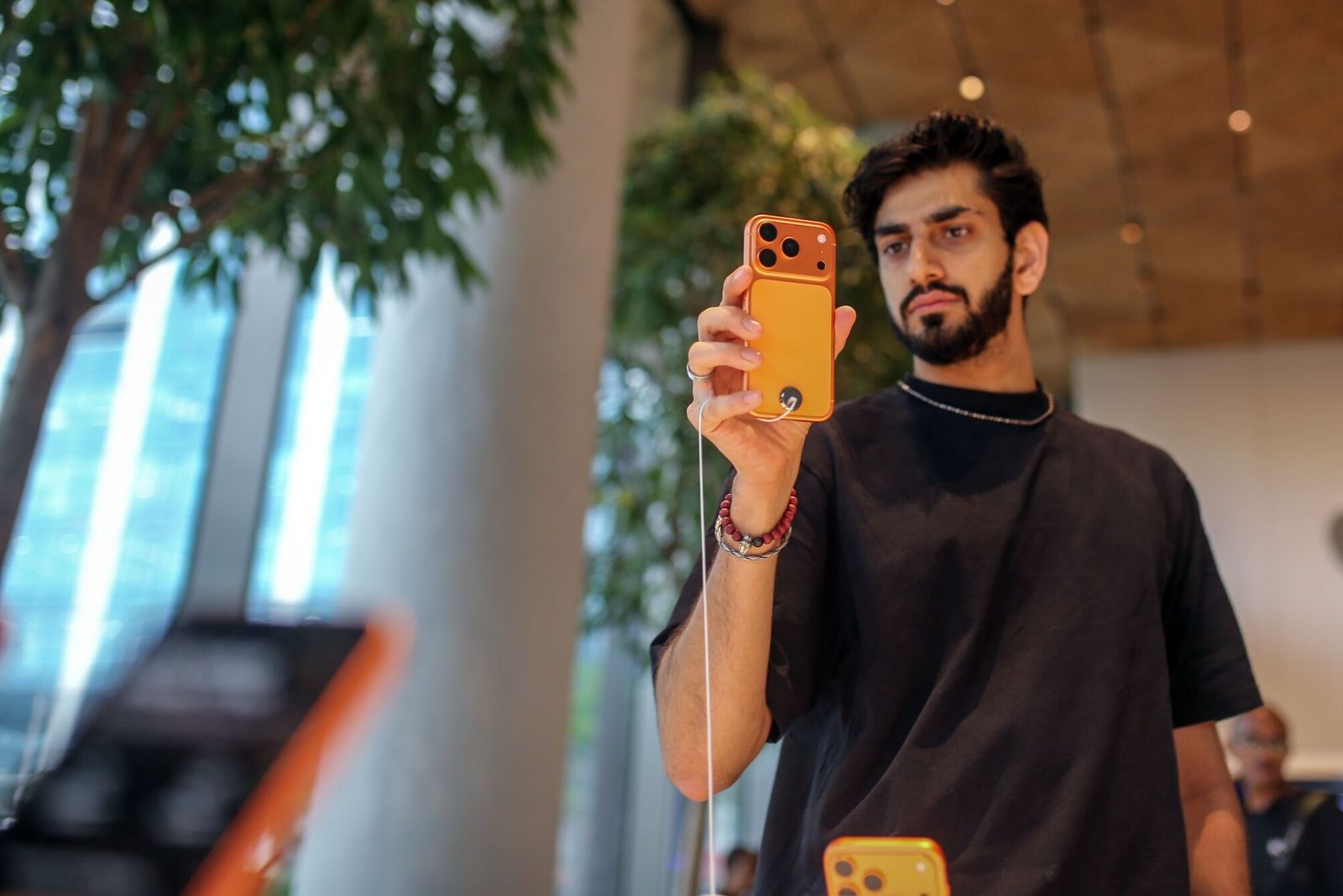 A customer looks at an Apple Inc. iPhone 17 Pro series smartphone at one of the company's stores during the first day of sales of the smartphones in Mumbai, India, on Friday, Sept. 19, 2025. For the past four years, some Apple Inc. customers have been waiting for a fresh design before buying a new iPhone. The time has come for those consumers, with the iPhone 17 Pro, iPhone 17 Pro Max and iPhone Air going on sale Friday. Photographer: Dhiraj Singh/Bloomberg