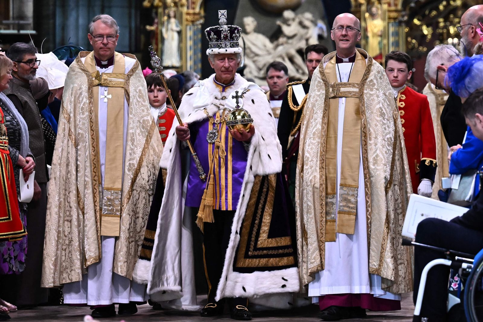 Britain's King Charles III wearing the Imperial state Crown carrying the Sovereign's Orb and Sceptre leaves Westminster Abbey after the Coronation Ceremonies in central London on May 6, 2023. - The set-piece coronation is the first in Britain in 70 years, and only the second in history to be televised. Charles will be the 40th reigning monarch to be crowned at the central London church since King William I in 1066. Outside the UK, he is also king of 14 other Commonwealth countries, including Australia, Canada and New Zealand. (Photo by Ben Stansall / POOL / AFP) - AFP