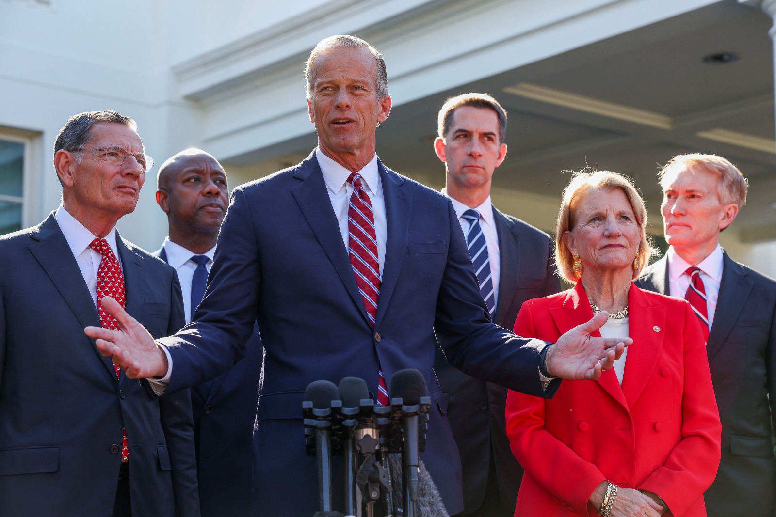 زعيم الأغلبية الجمهورية في مجلس الشيوخ جون ثون  يتحدث إلى الصحافيين في البيت الأبيض وإلى جانبه أعضاء جمهوريون بعد اجتماعهم مع الرئيس الأميركي دونالد ترمب. واشنطن. 21 أكتوبر 2025